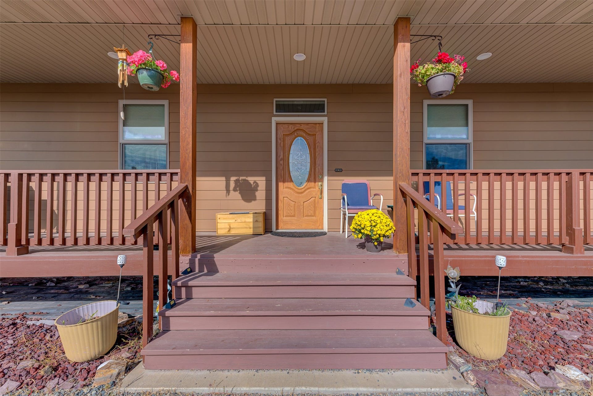 8224 Hillside Drive, Helena, MT 59602 Covered front porch with wood-finish railings, steps, and support posts