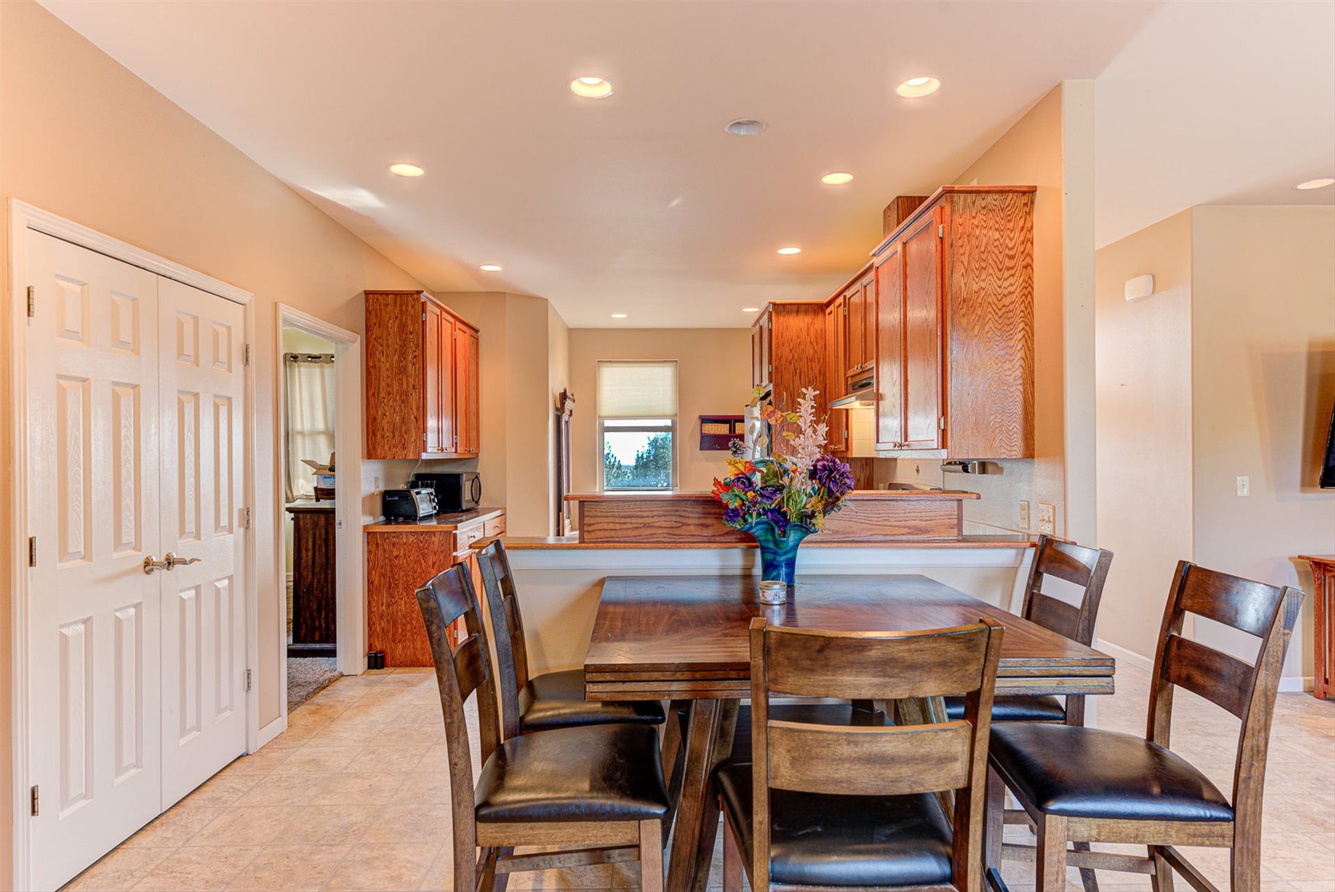 8224 Hillside Drive, Helena, MT 59602 Spacious dining area featuring tile flooring, vaulted ceiling, and recessed lighting