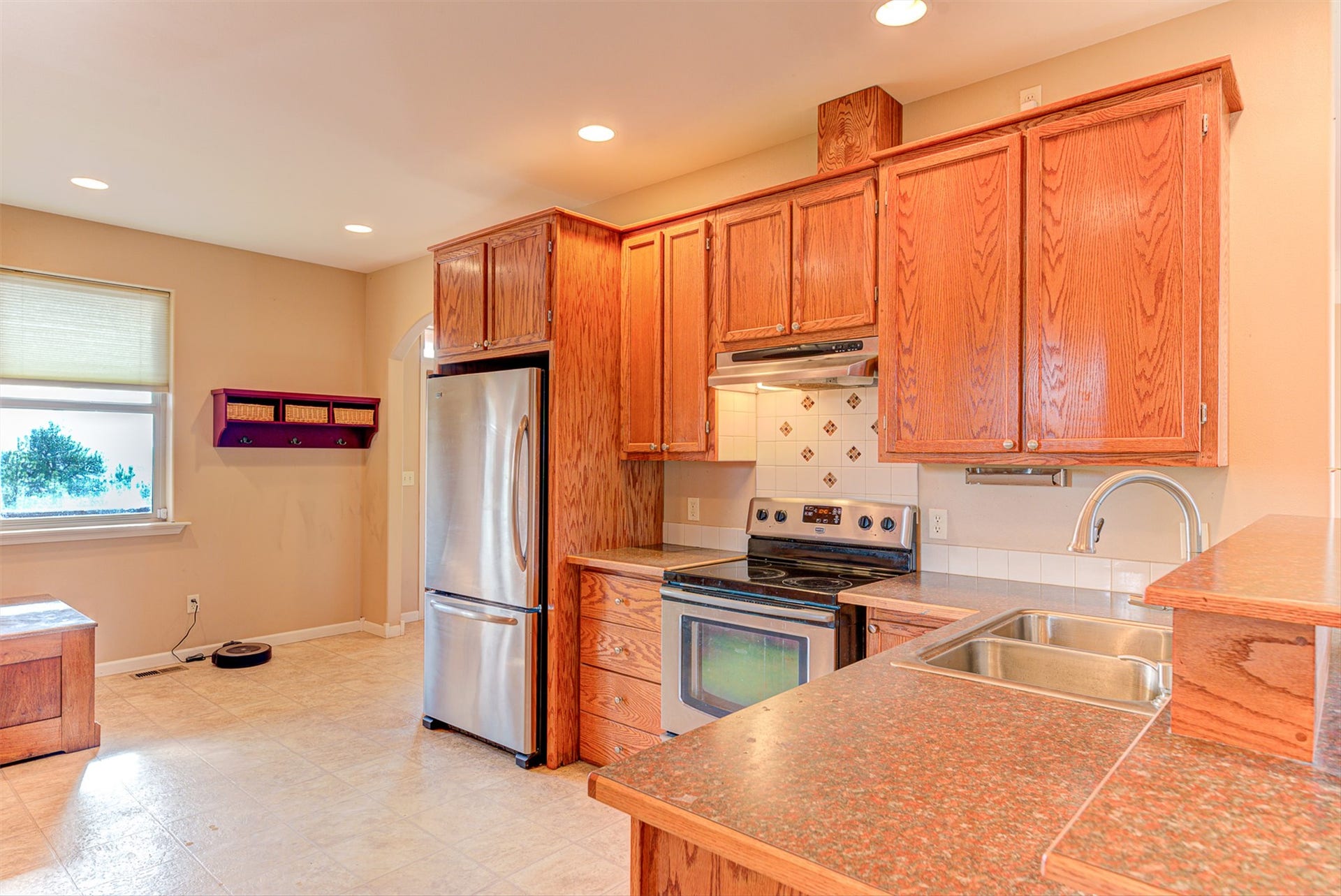 8224 Hillside Drive, Helena, MT 59602 Kitchen featuring wood cabinetry, stainless steel appliances, a double basin sink, and recessed lighting