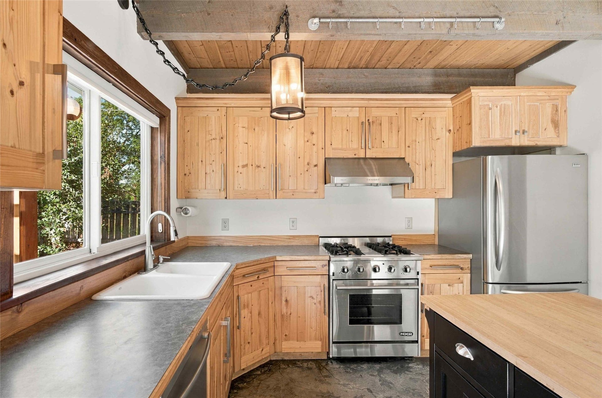 Wood-finish cabinetry paired with stainless steel appliances