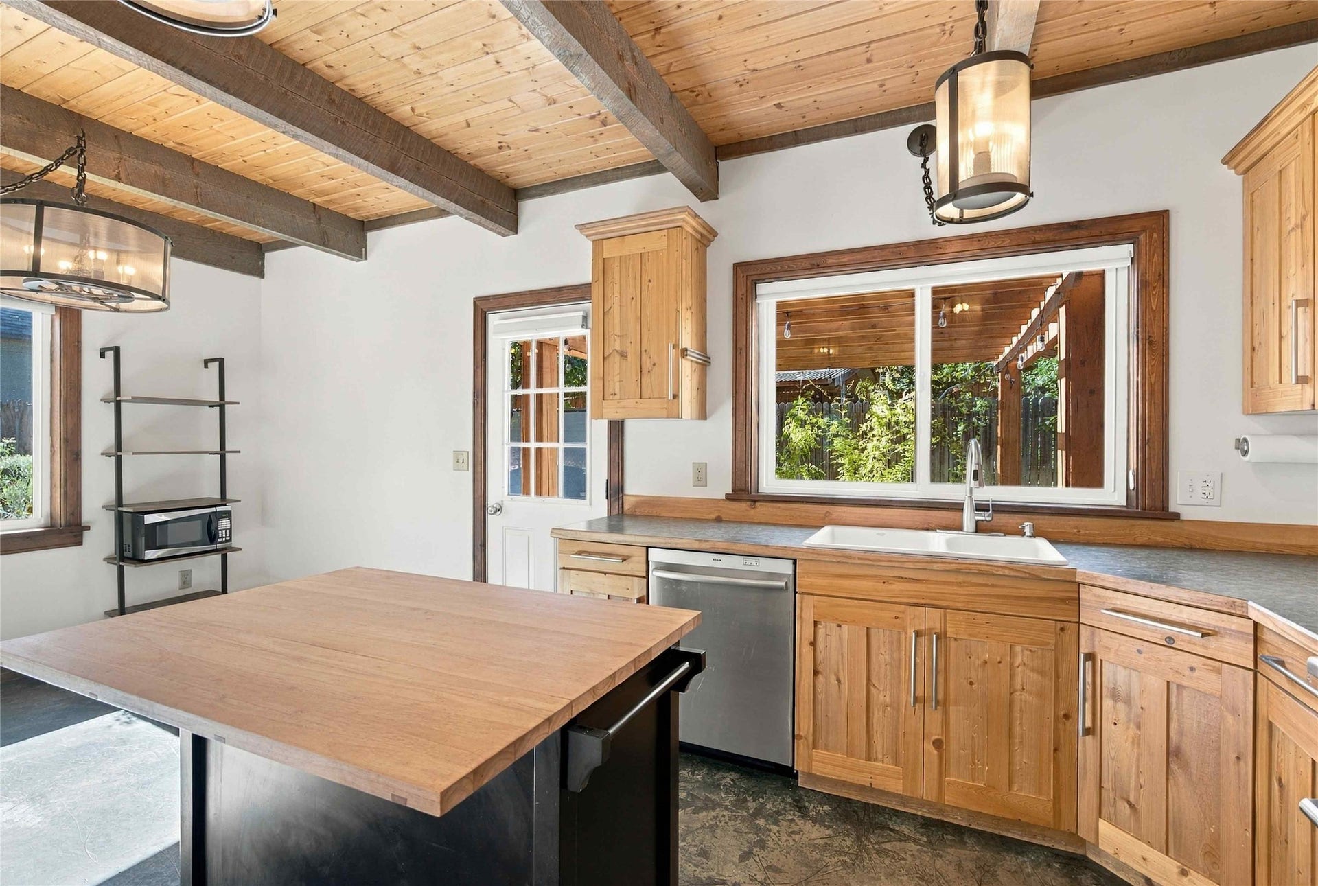 Wood-paneled vaulted ceiling with exposed beams