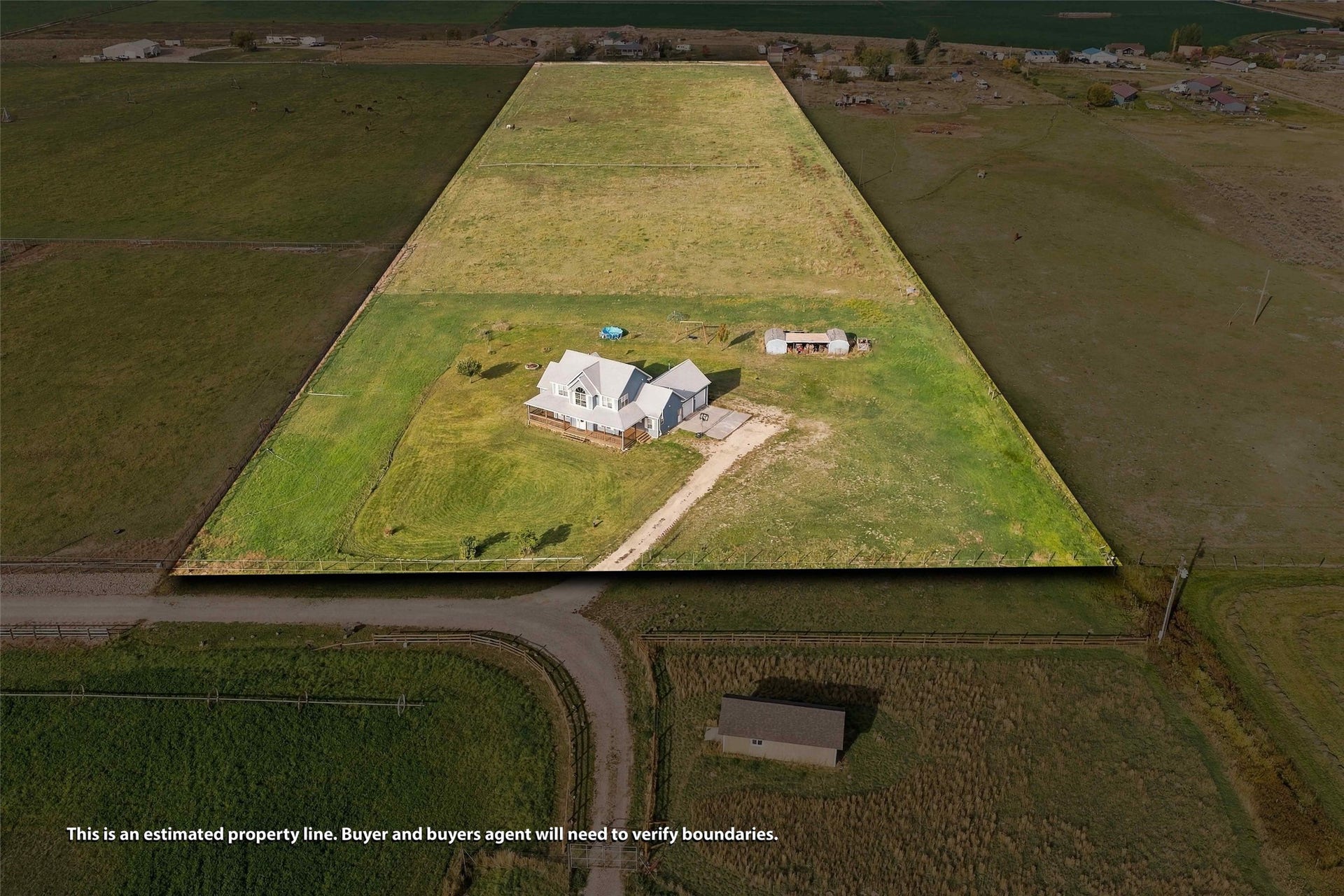 Expansive property featuring a large residence, a secondary outbuilding, and significant open land