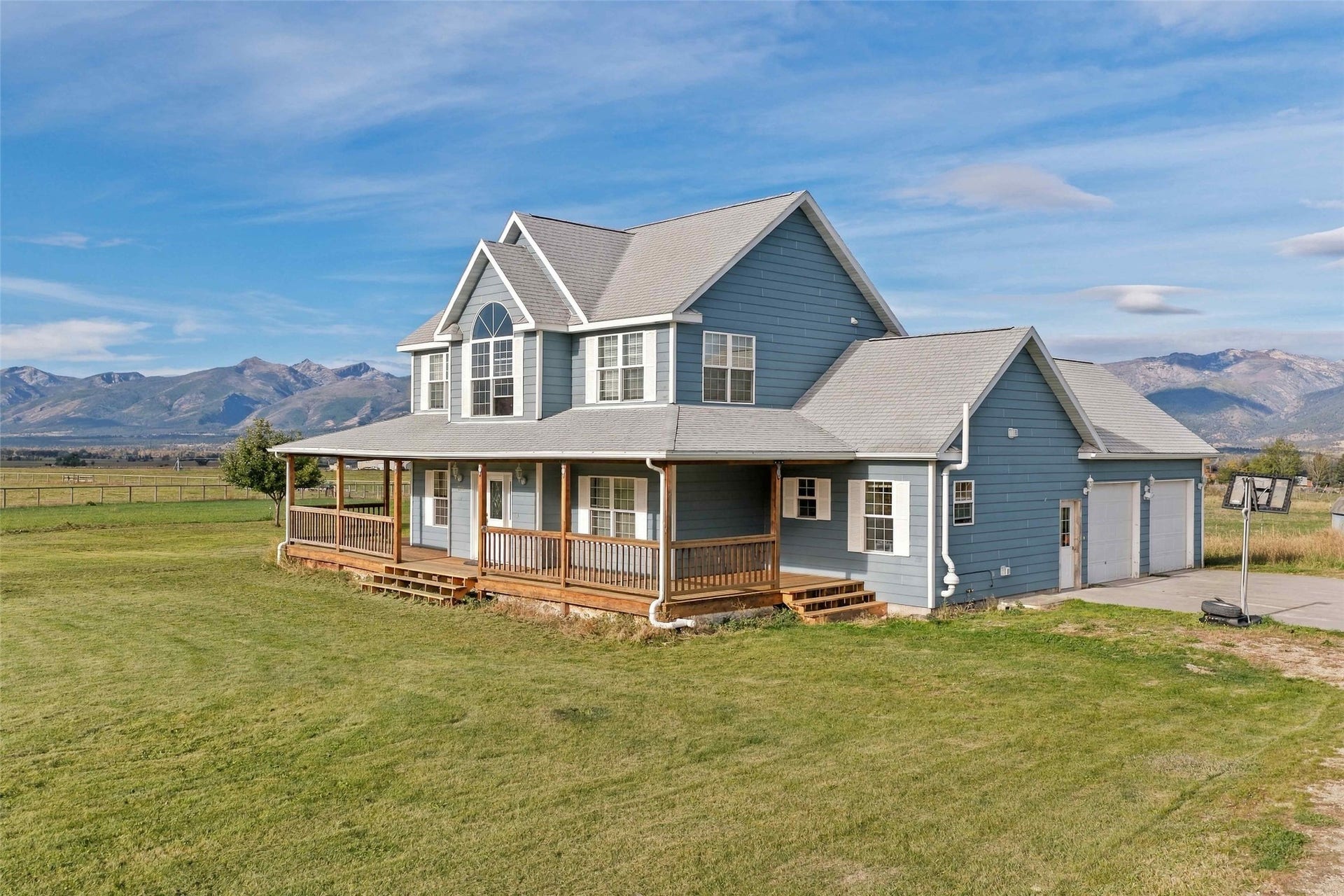 Two-story residence featuring blue siding and white trim
