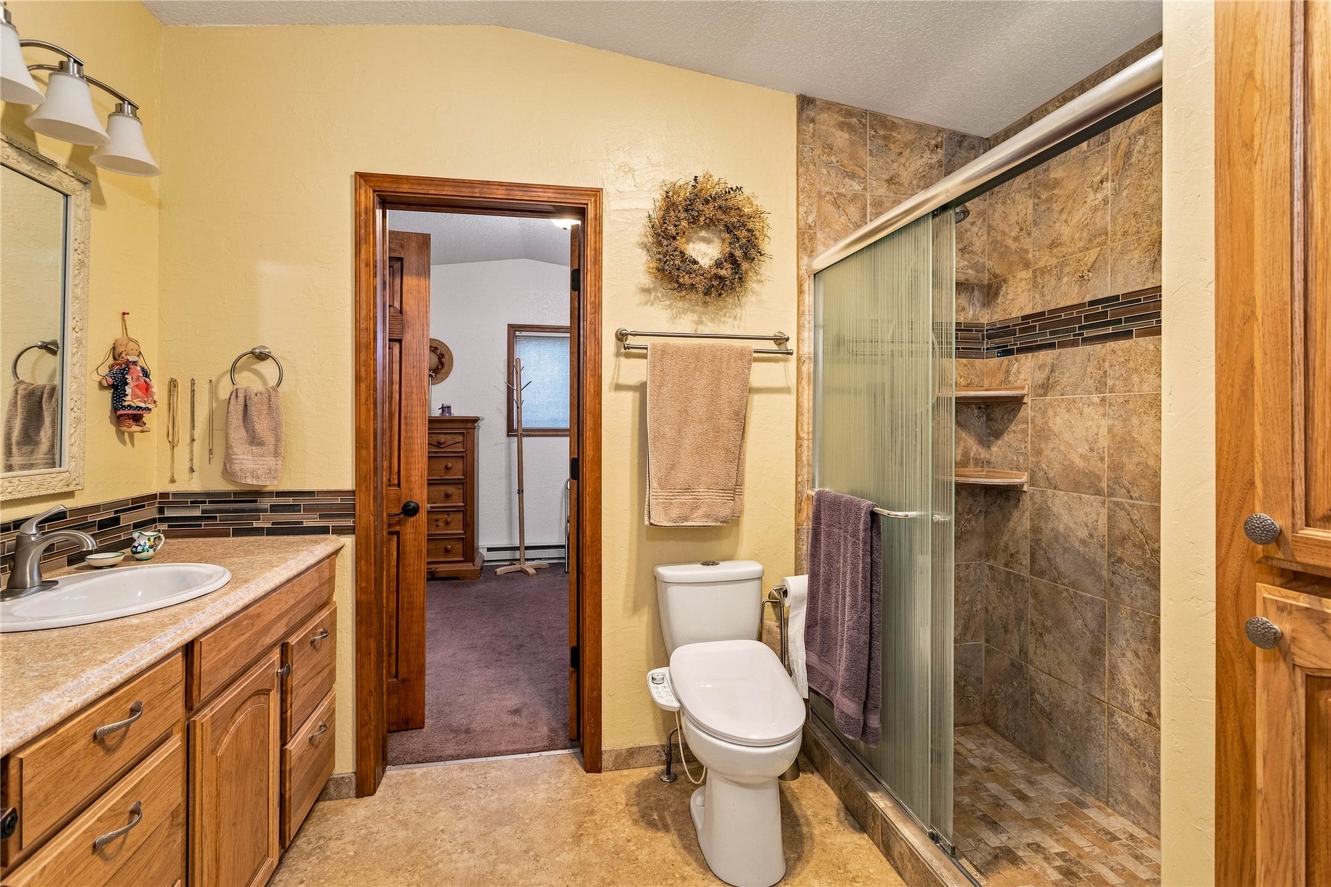 Tile and stone bathroom shared by upper bedrooms