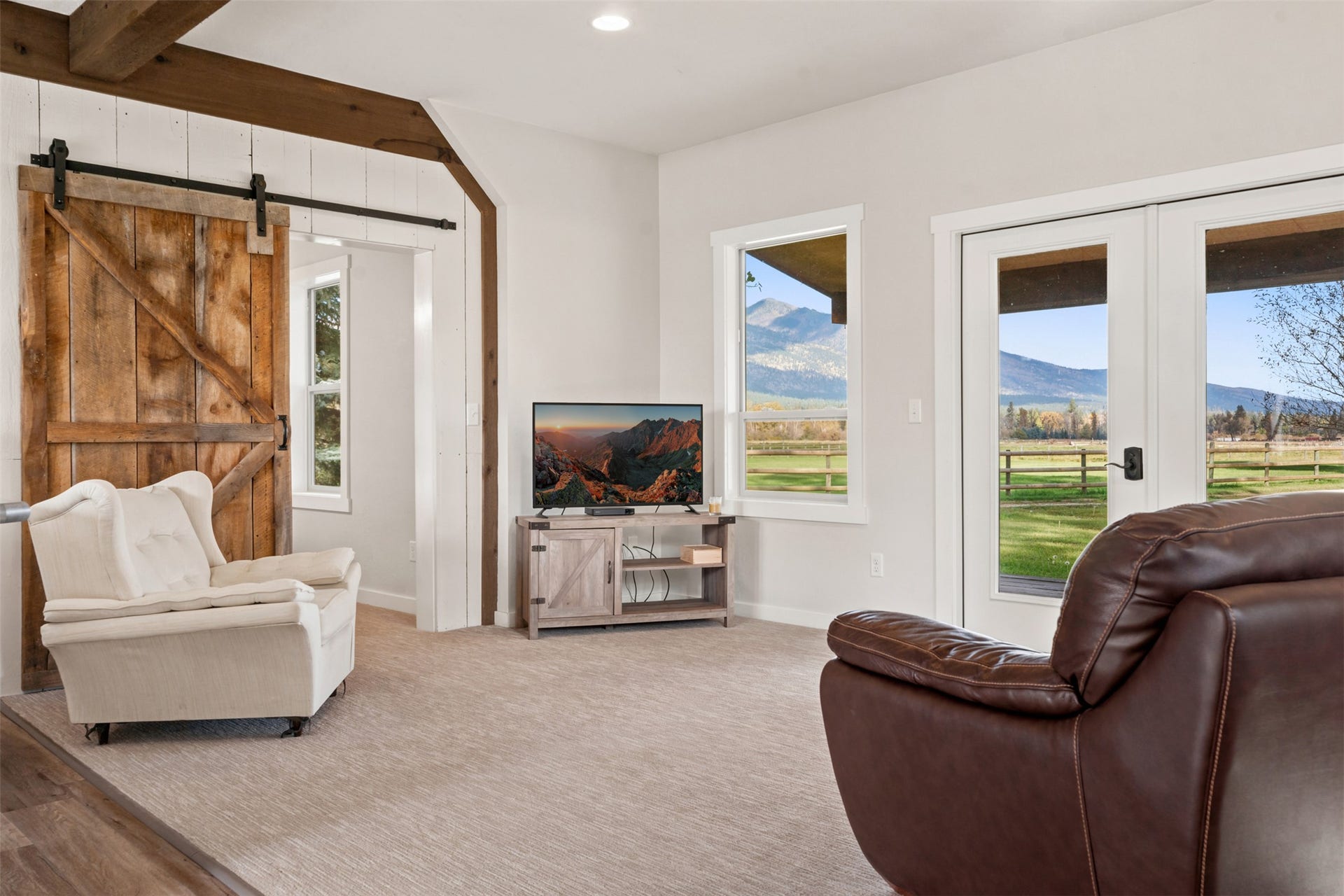 5165 Moores Way, Florence, MT 59833 Guest house living room with carpet and barn door with double doors to the back yard