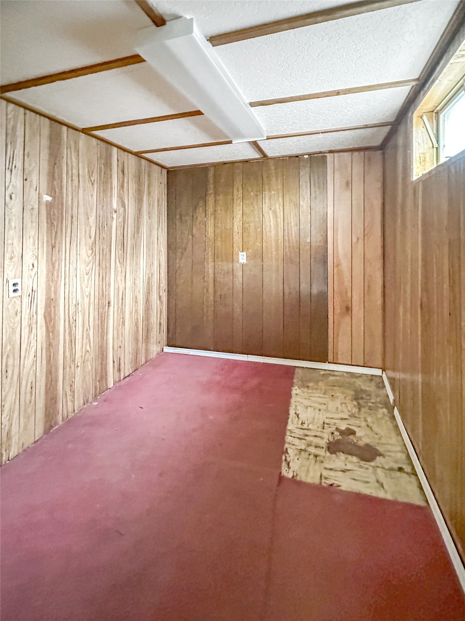 1123 2nd Street N, Shelby, MT 59474 Wood paneling walls, textured ceiling, fluorescent ceiling light fixture, small window opening