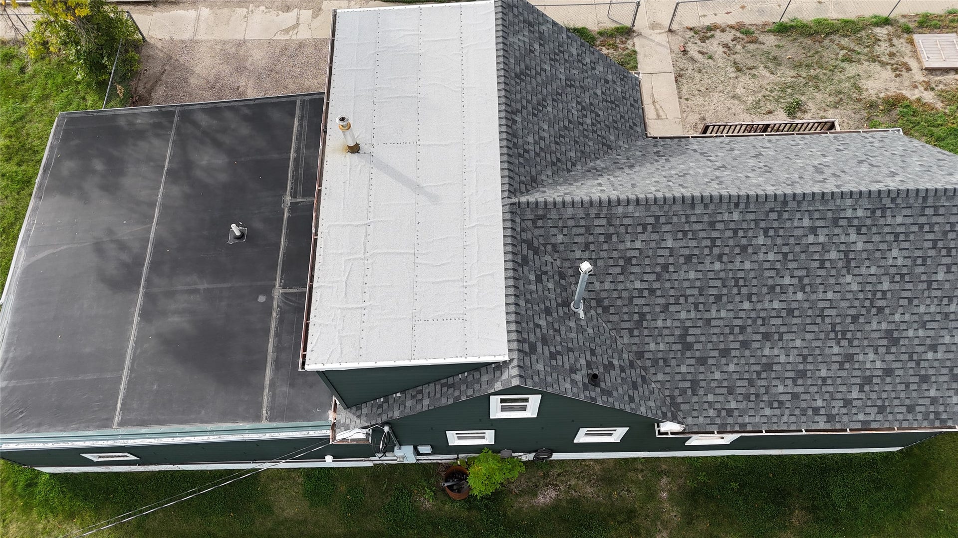 1123 2nd Street N, Shelby, MT 59474 Multiple roofing styles including asphalt shingles and flat membrane. White on upstairs. Black on lower.