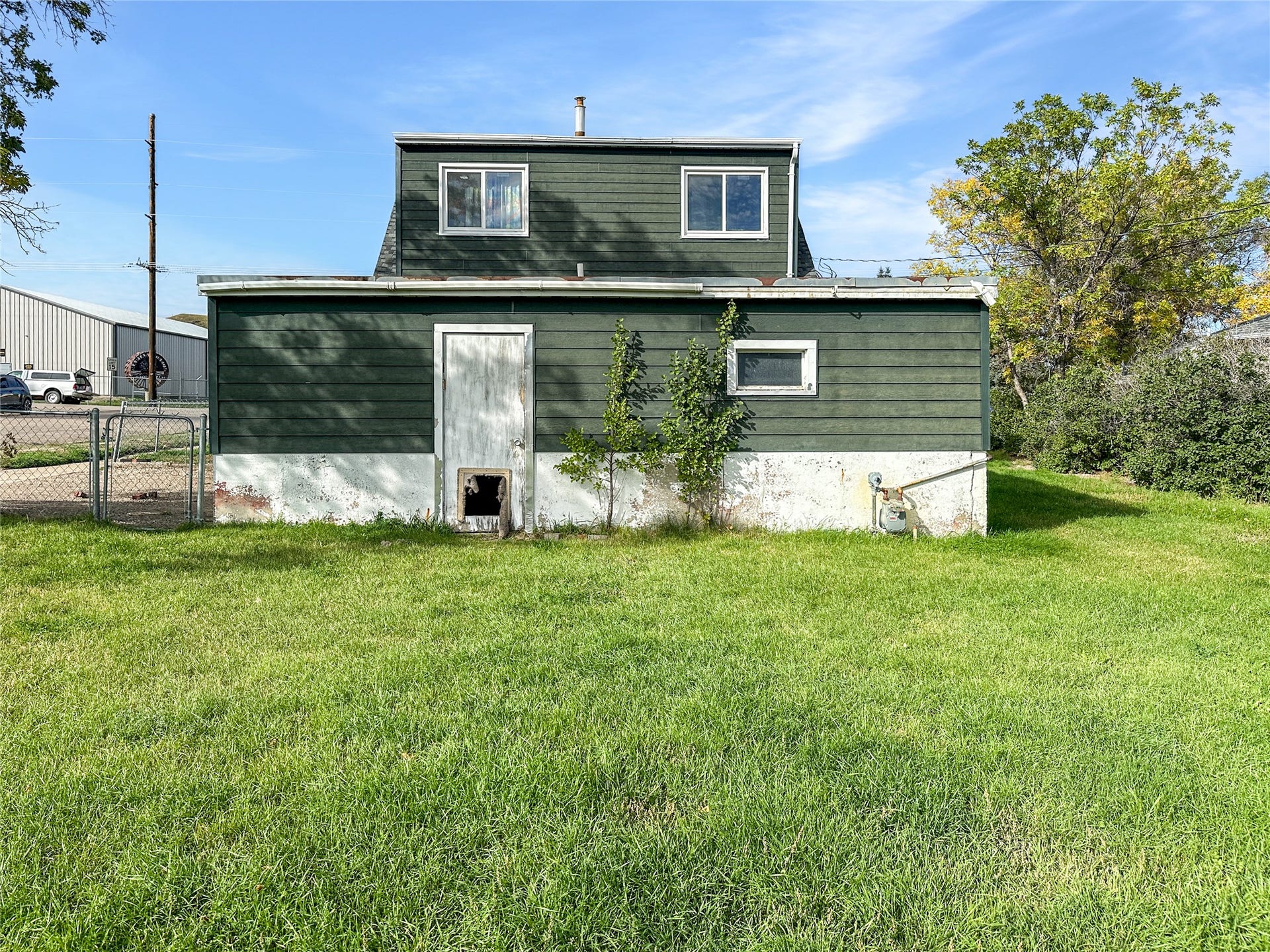 1123 2nd Street N, Shelby, MT 59474 Green horizontal siding with a white foundation