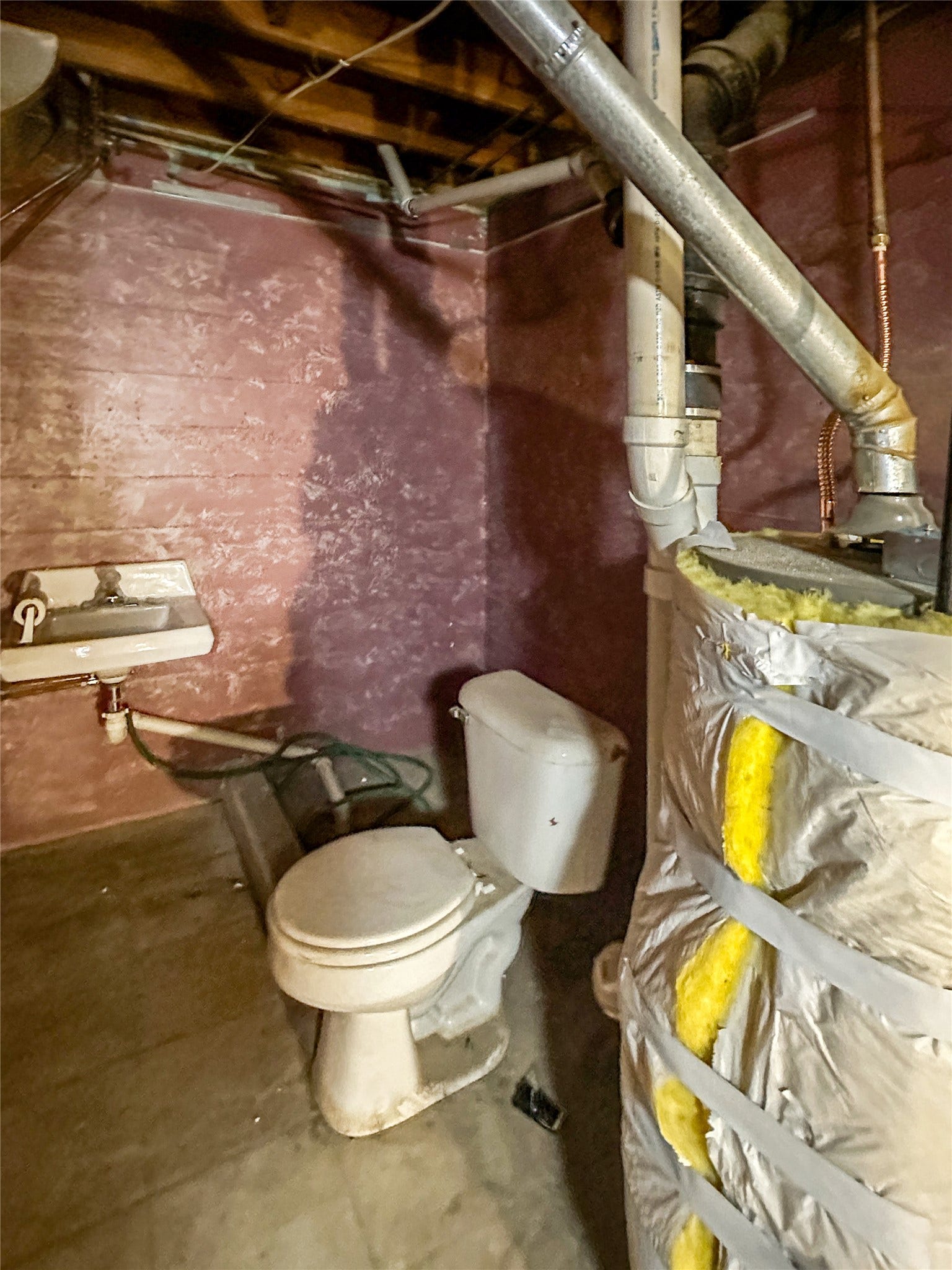 1123 2nd Street N, Shelby, MT 59474 concrete floors, unfinished walls, open ceiling, water heater, toilet, sink on wall