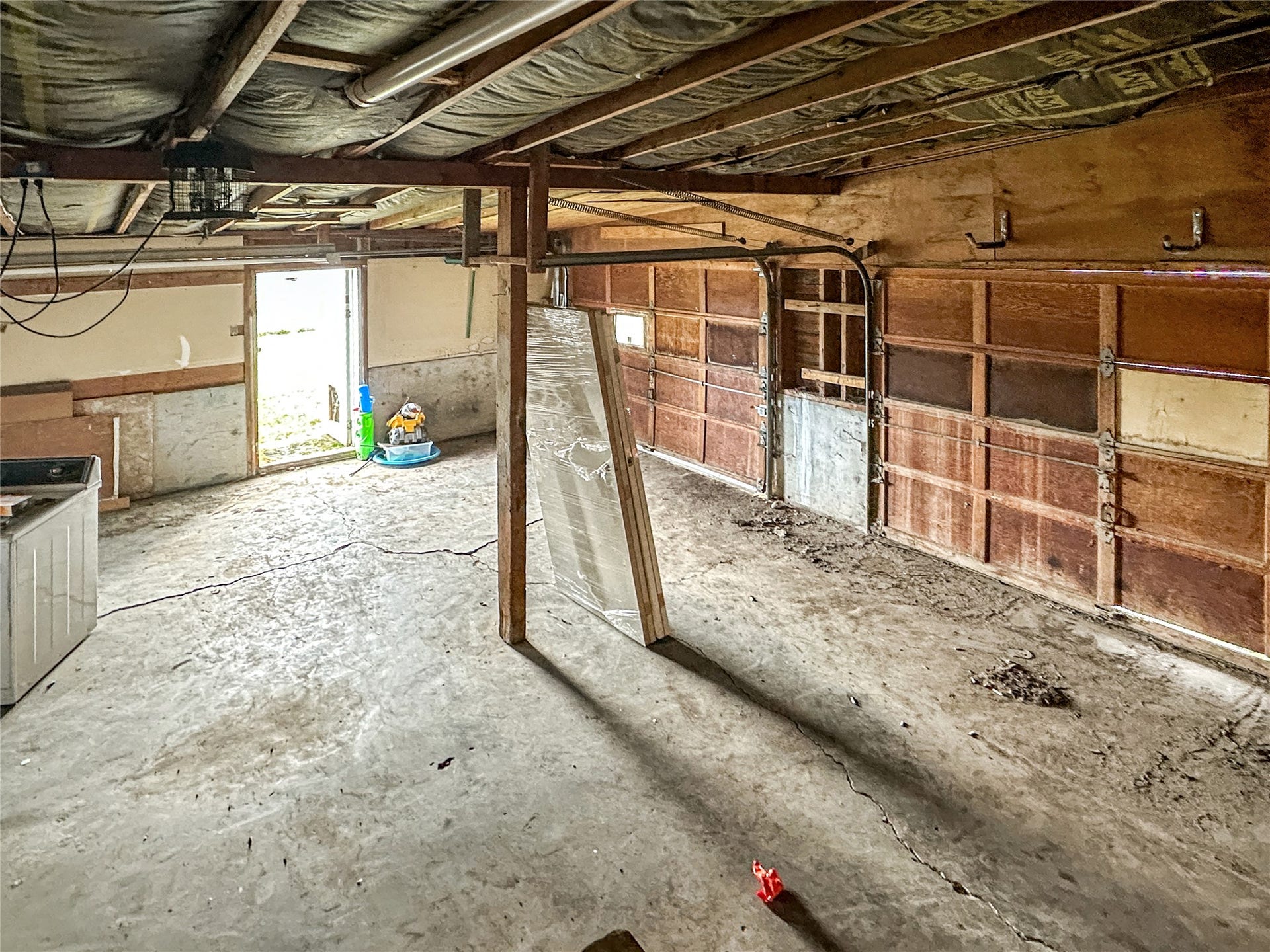 1123 2nd Street N, Shelby, MT 59474 Concrete floors, wooden doors, side door, unfinished walls, support beam, unfinished ceilings