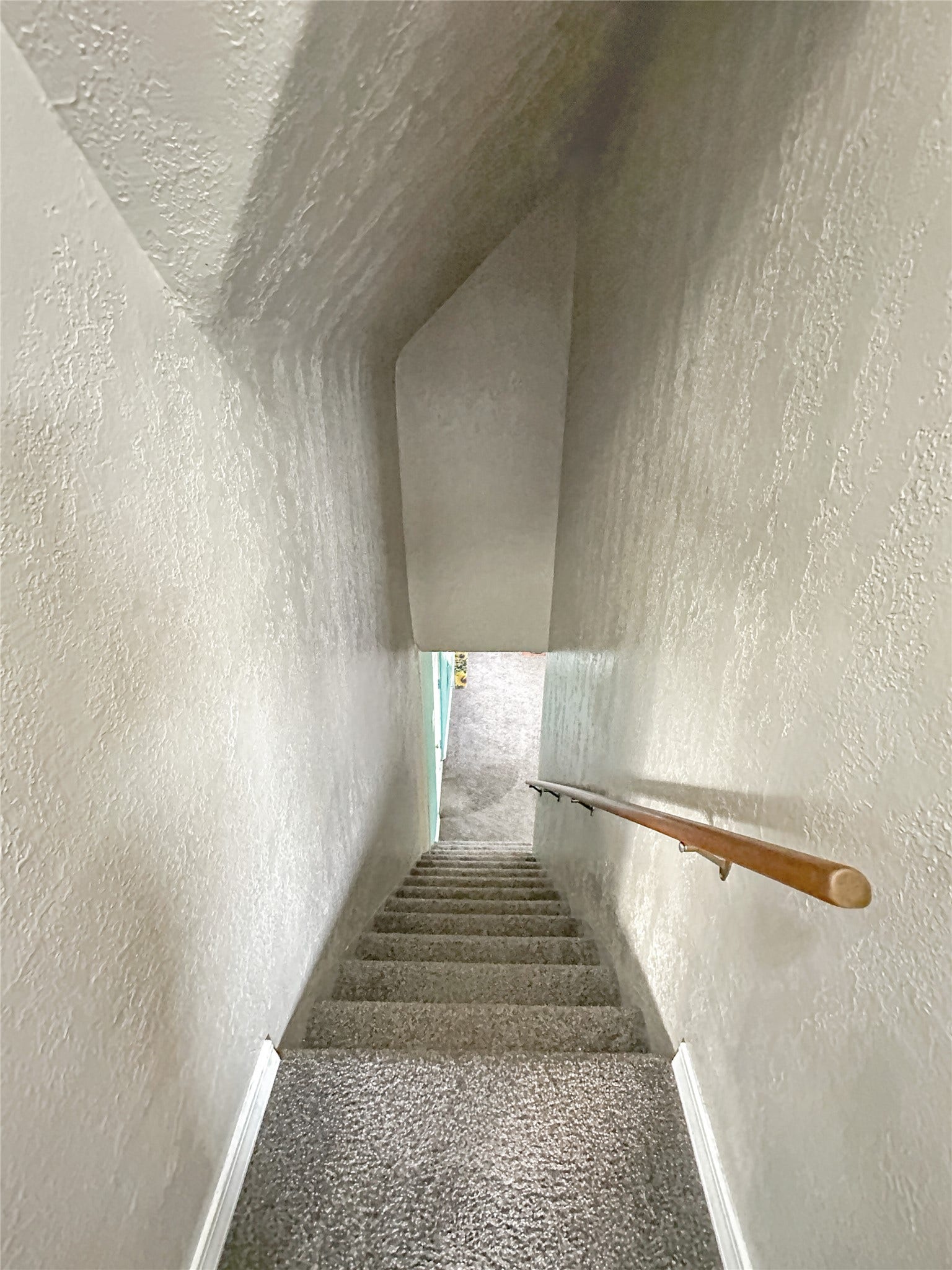 1123 2nd Street N, Shelby, MT 59474 Carpeted staircase with a wood handrail and textured walls