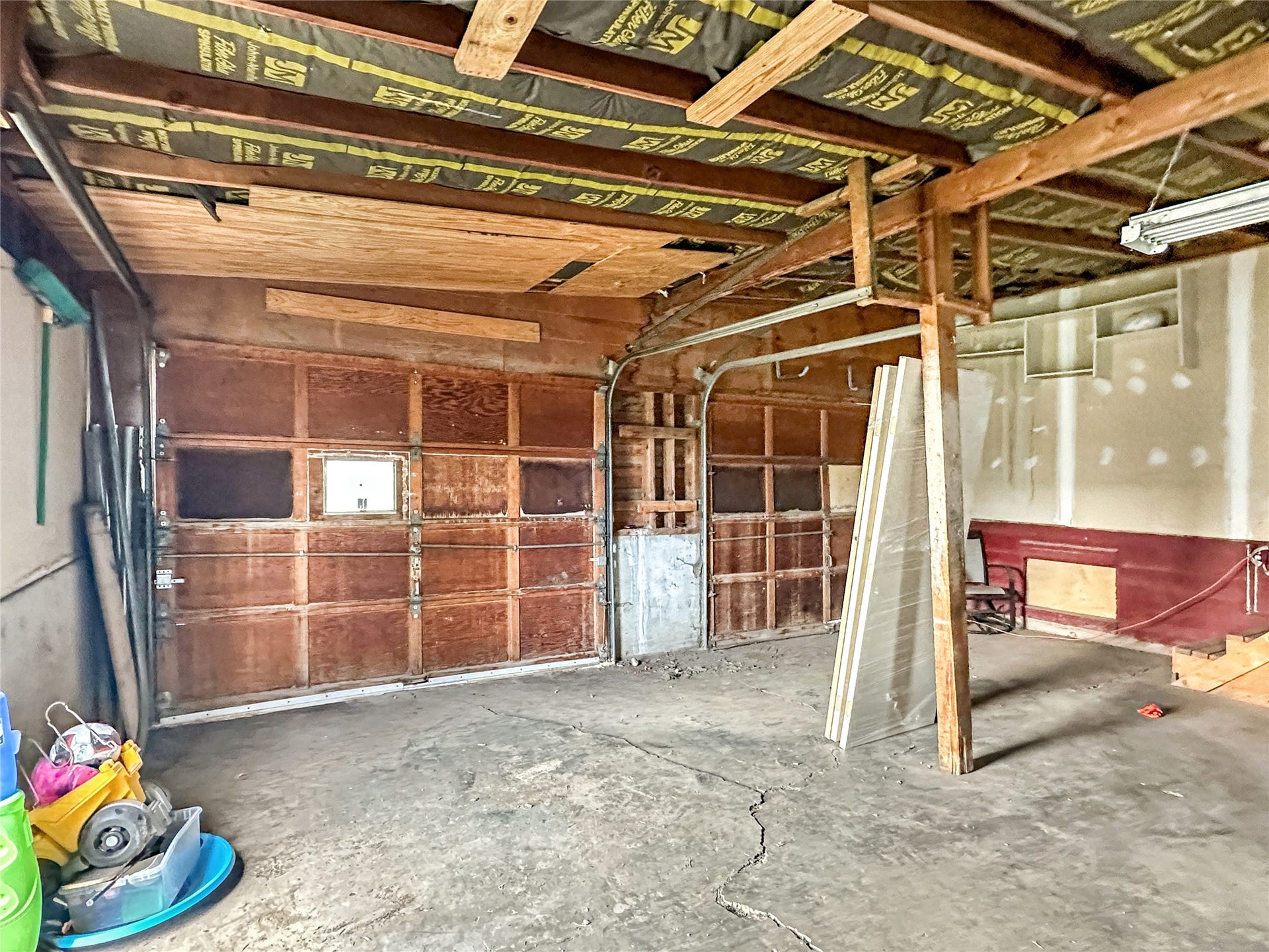 1123 2nd Street N, Shelby, MT 59474 Concrete floors, wooden doors, side door, unfinished walls, support beam, unfinished ceilings