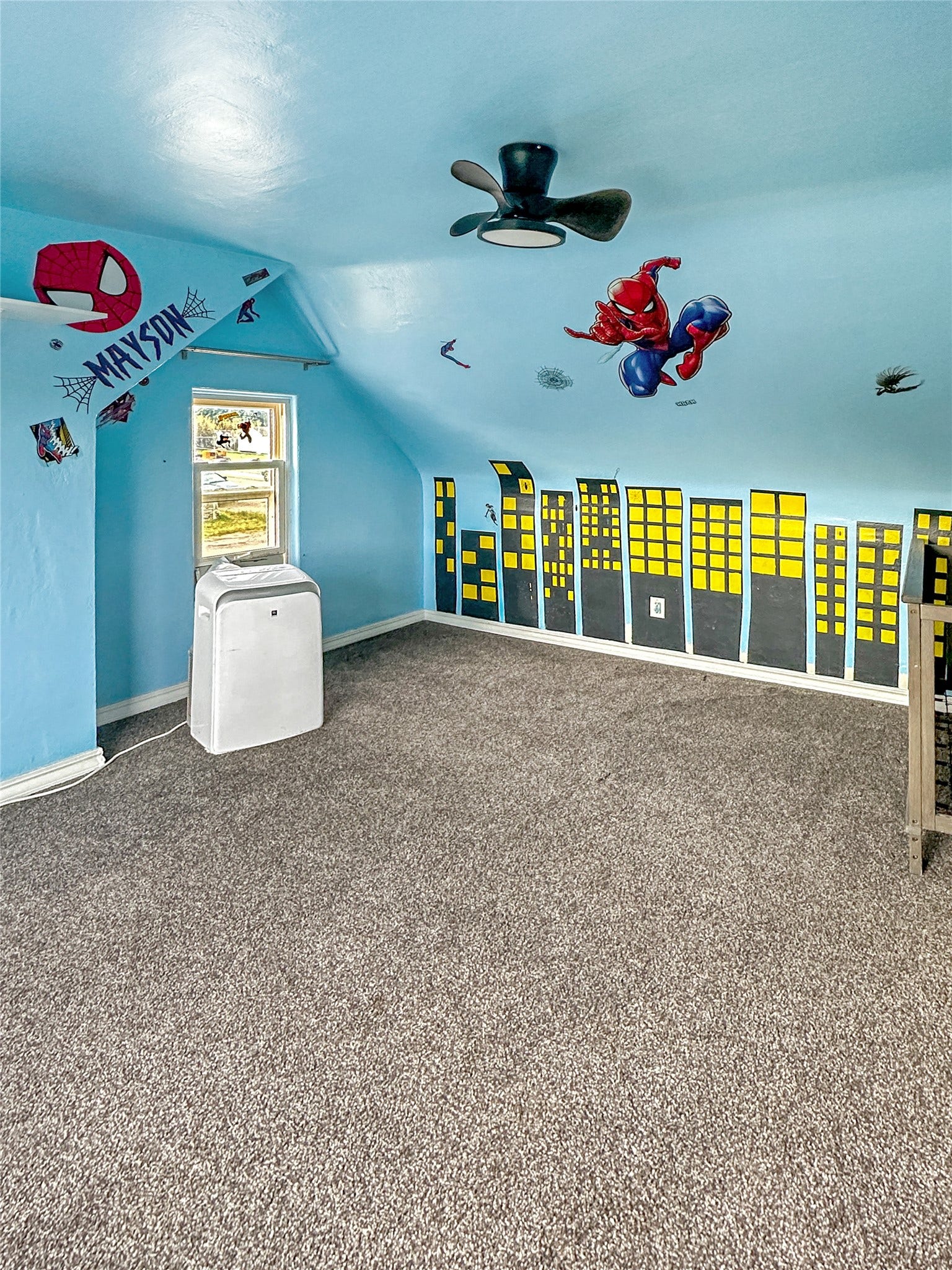 1123 2nd Street N, Shelby, MT 59474 Sloped ceiling, textured carpet flooring, window, and ceiling fan
