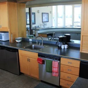 A-5 Eagle Bend Yacht Harbor 22', Bigfork, MT 59911 Kitchenette featuring wood-finish cabinetry, stainless steel sink with a high-arc faucet, and dark countertops