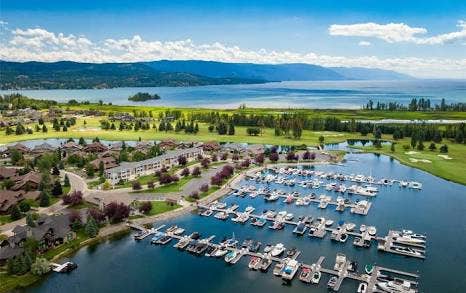 A-5 Eagle Bend Yacht Harbor 22', Bigfork, MT 59911 Expansive marina with numerous boat slips, surrounded by waterfront properties and a manicured golf course