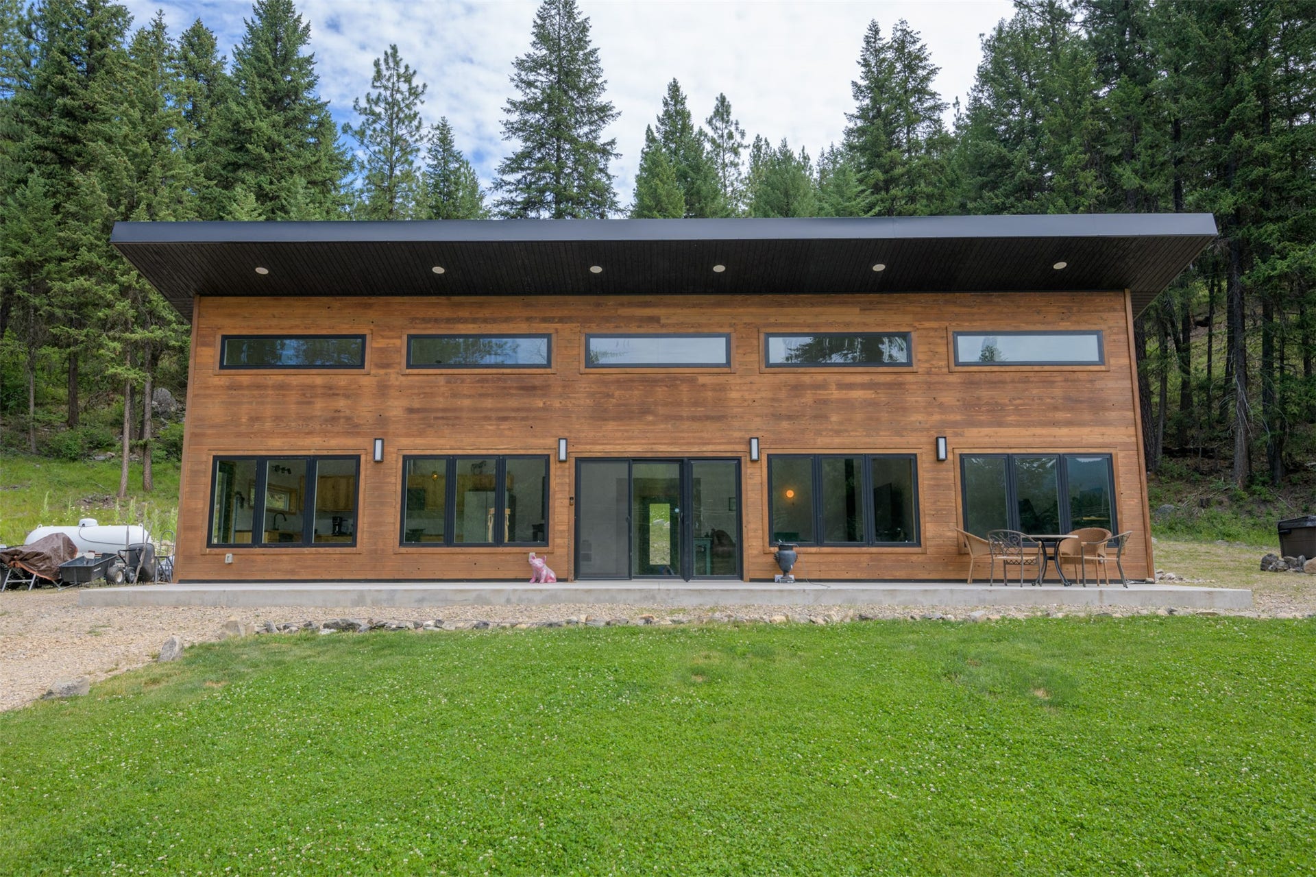 Contemporary exterior with wood-finish siding, black-framed windows, and a flat roofline