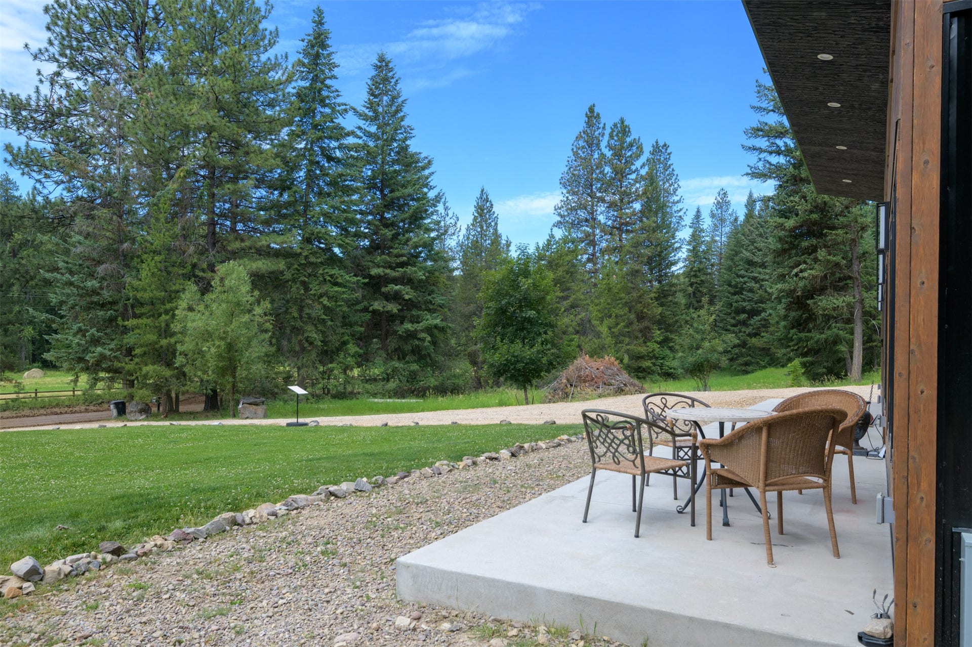 Concrete patio with a wood-paneled exterior