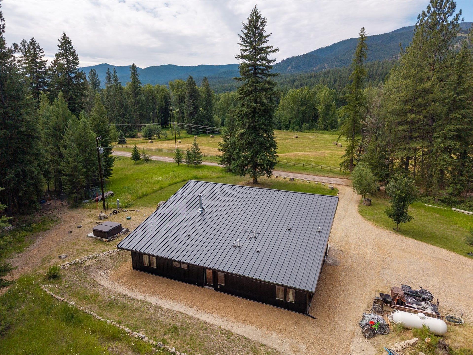 Contemporary single-story residence with a dark exterior and a metal roof