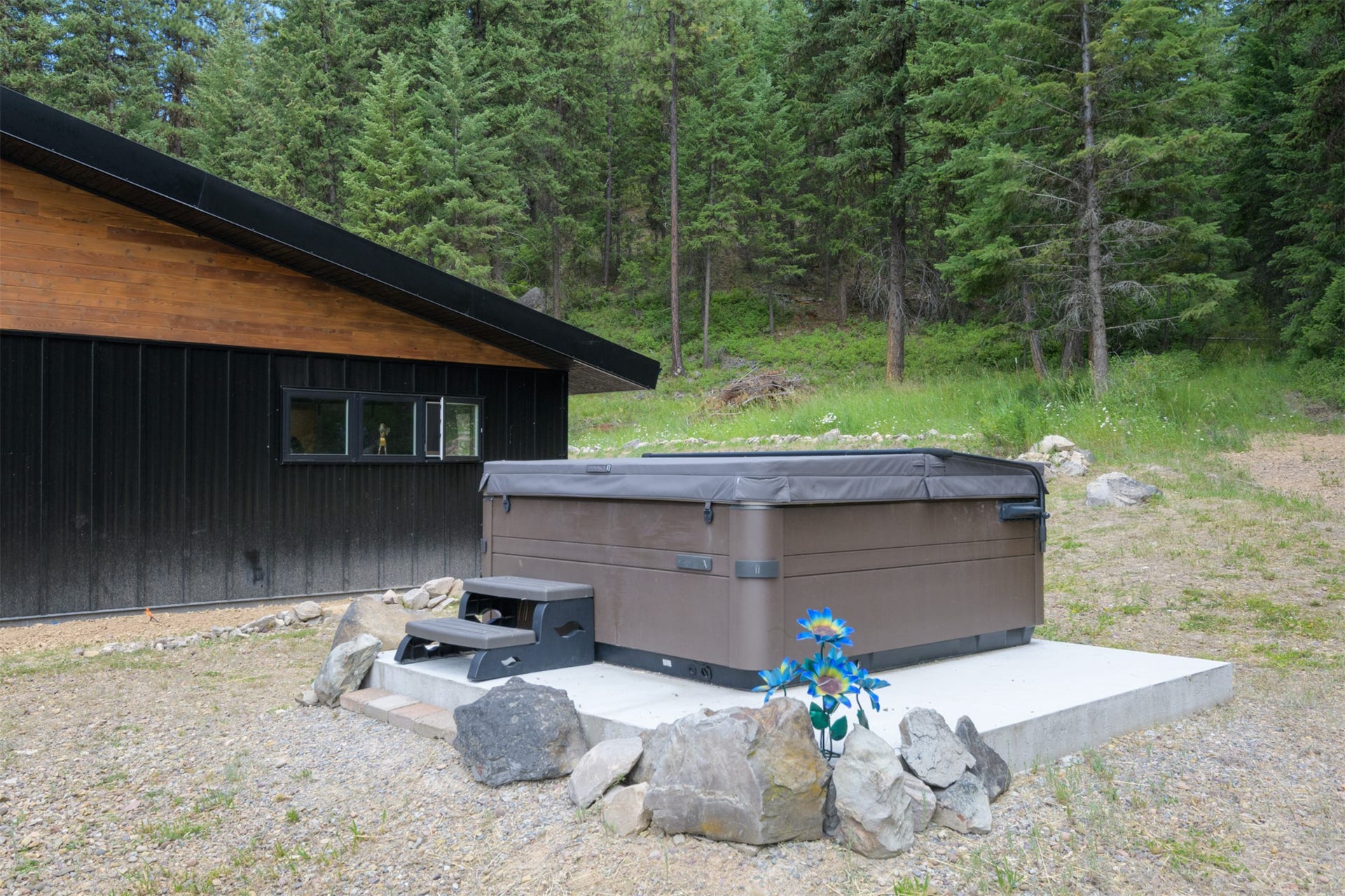 Modern exterior siding with black corrugated metal and wood-finish accents