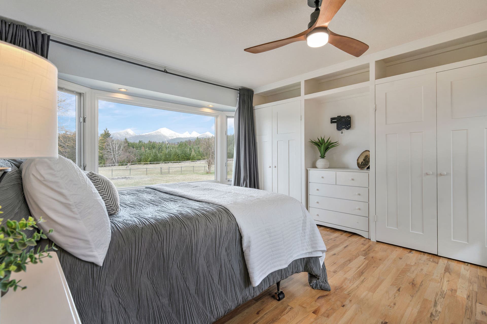 170 Kohler Lake Lane, Kalispell, MT 59901 Primary bedroom, en suite, large picture windows, wood flooring, built-in cabinetry