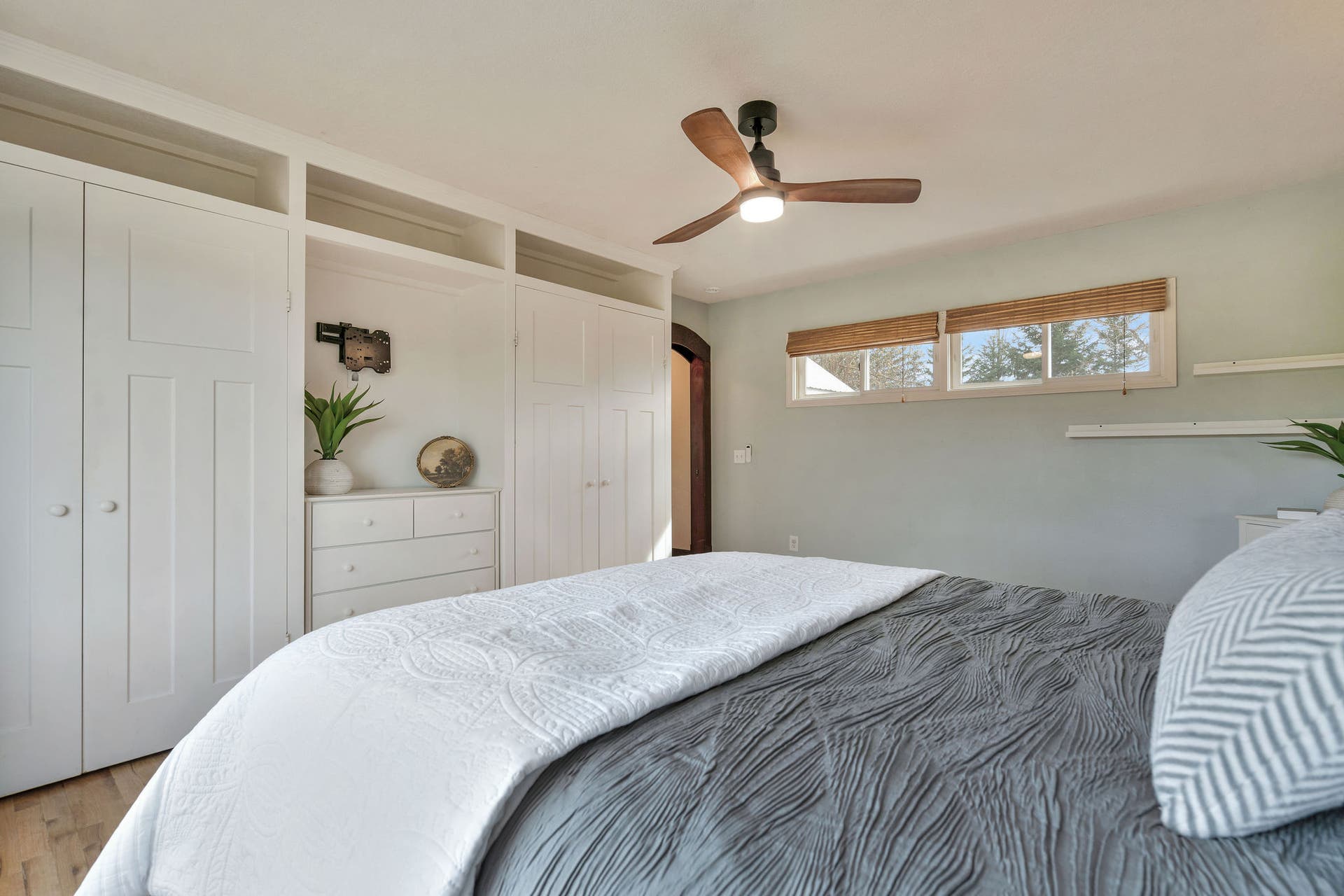 170 Kohler Lake Lane, Kalispell, MT 59901 Primary bedroom, en suite, large picture windows, wood flooring, built-in cabinetry