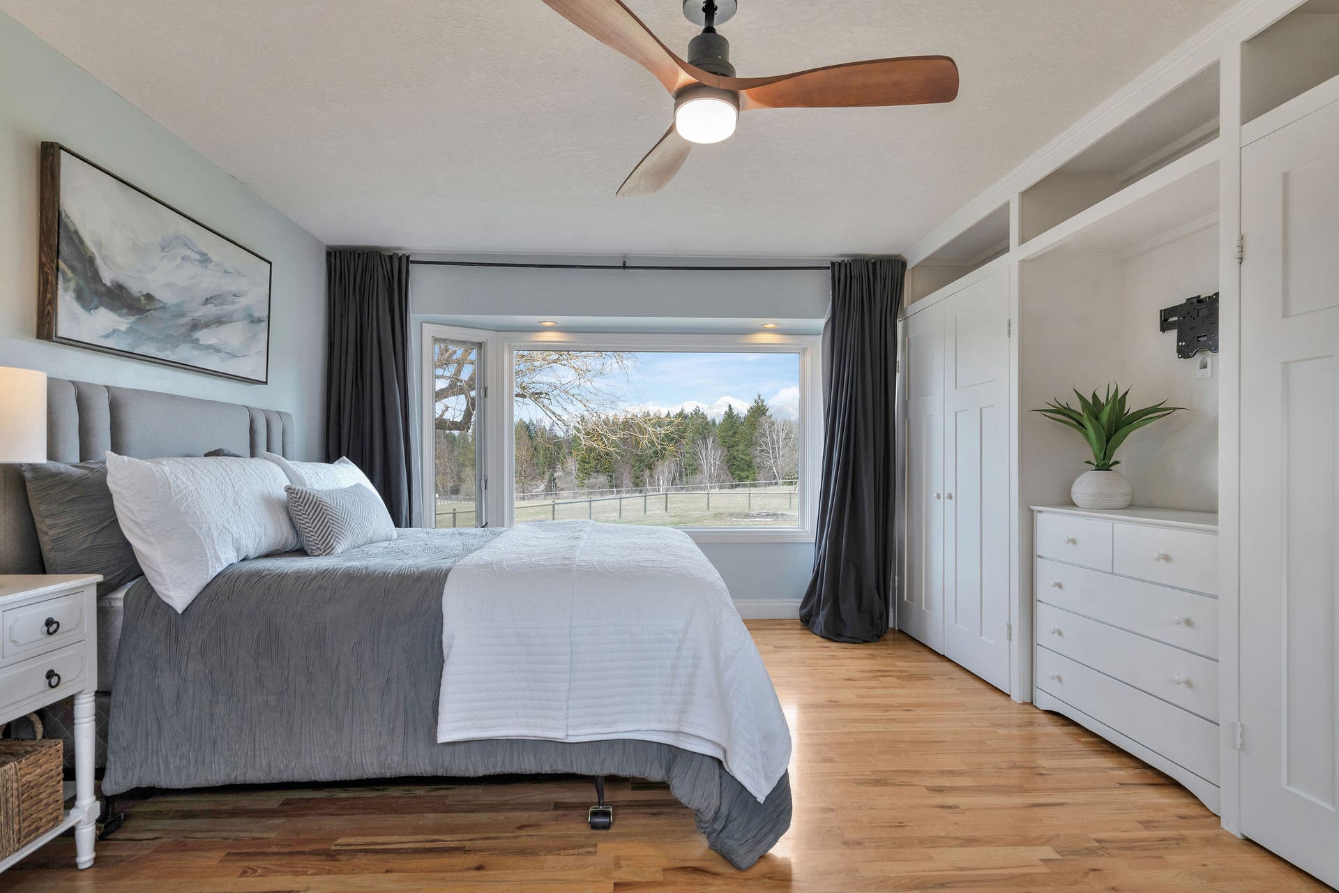 170 Kohler Lake Lane, Kalispell, MT 59901 Primary bedroom, en suite, large picture windows, wood flooring, built-in cabinetry