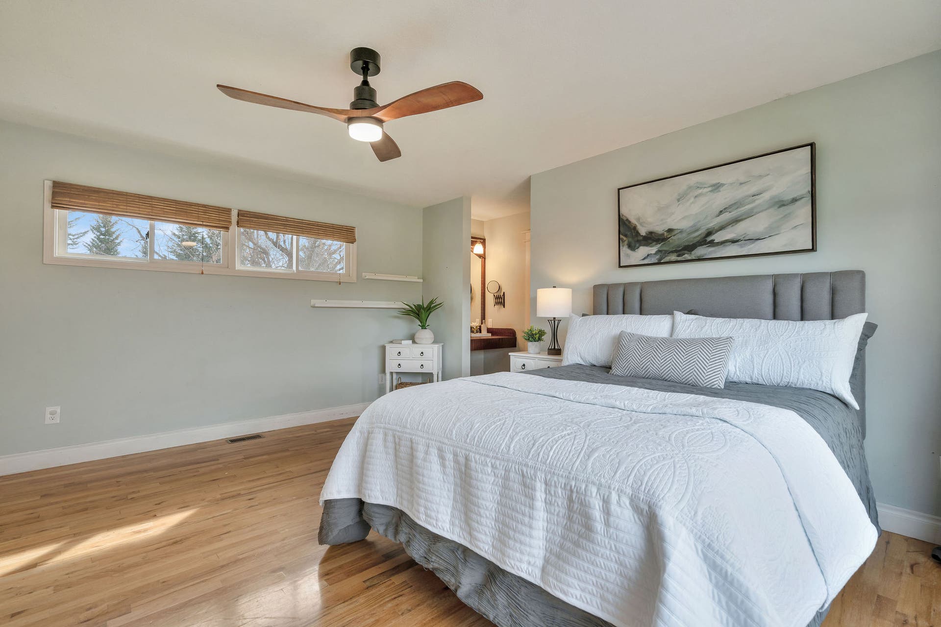 170 Kohler Lake Lane, Kalispell, MT 59901 Primary bedroom, en suite, large picture windows, wood flooring, built-in cabinetry