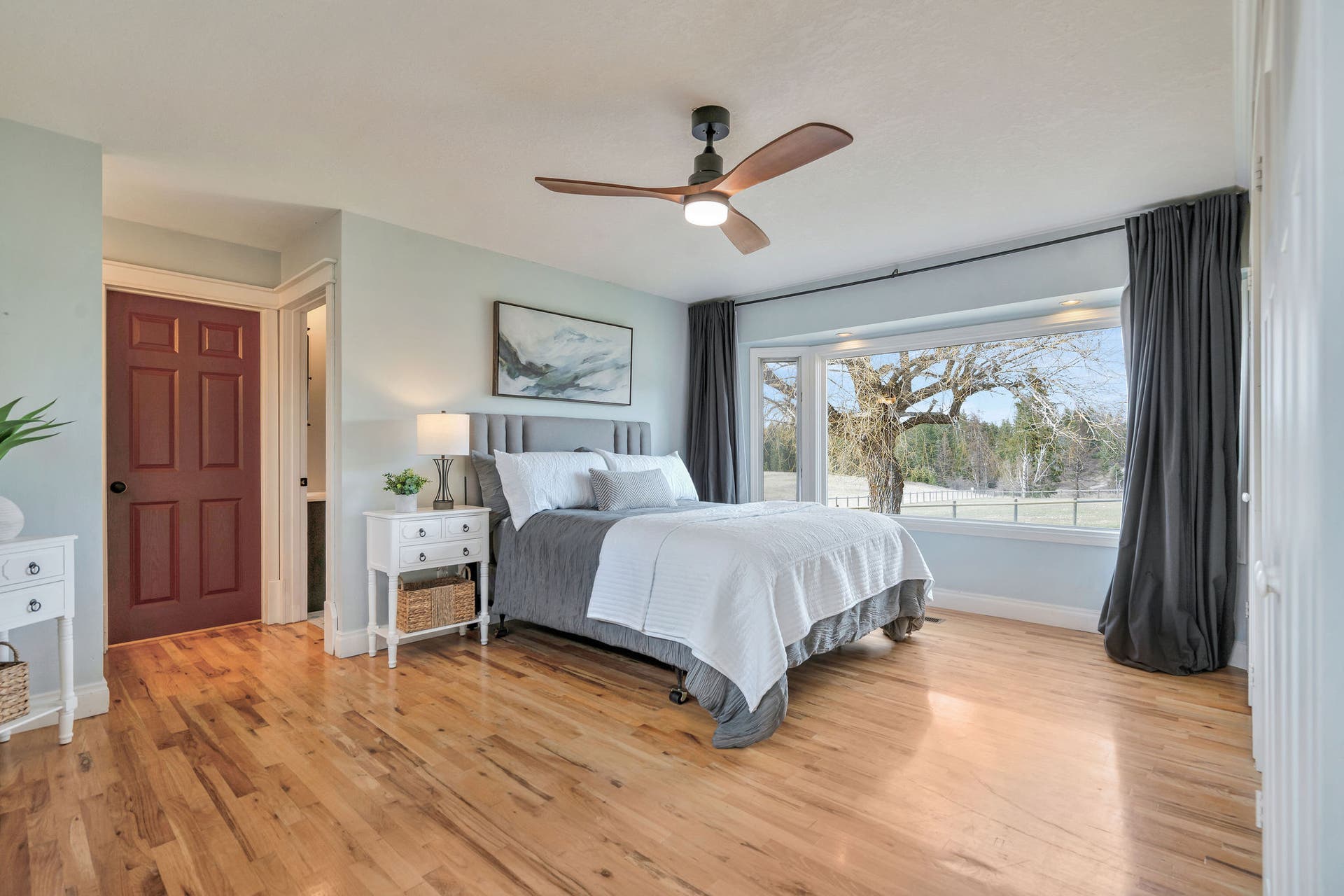 170 Kohler Lake Lane, Kalispell, MT 59901 Primary bedroom, en suite, large picture windows, wood flooring, built-in cabinetry