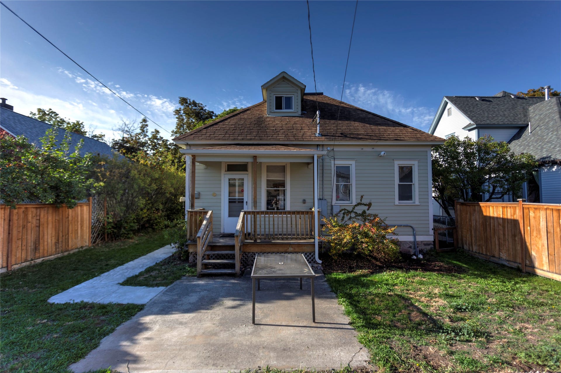 Light-colored siding exterior with a brown shingle roof