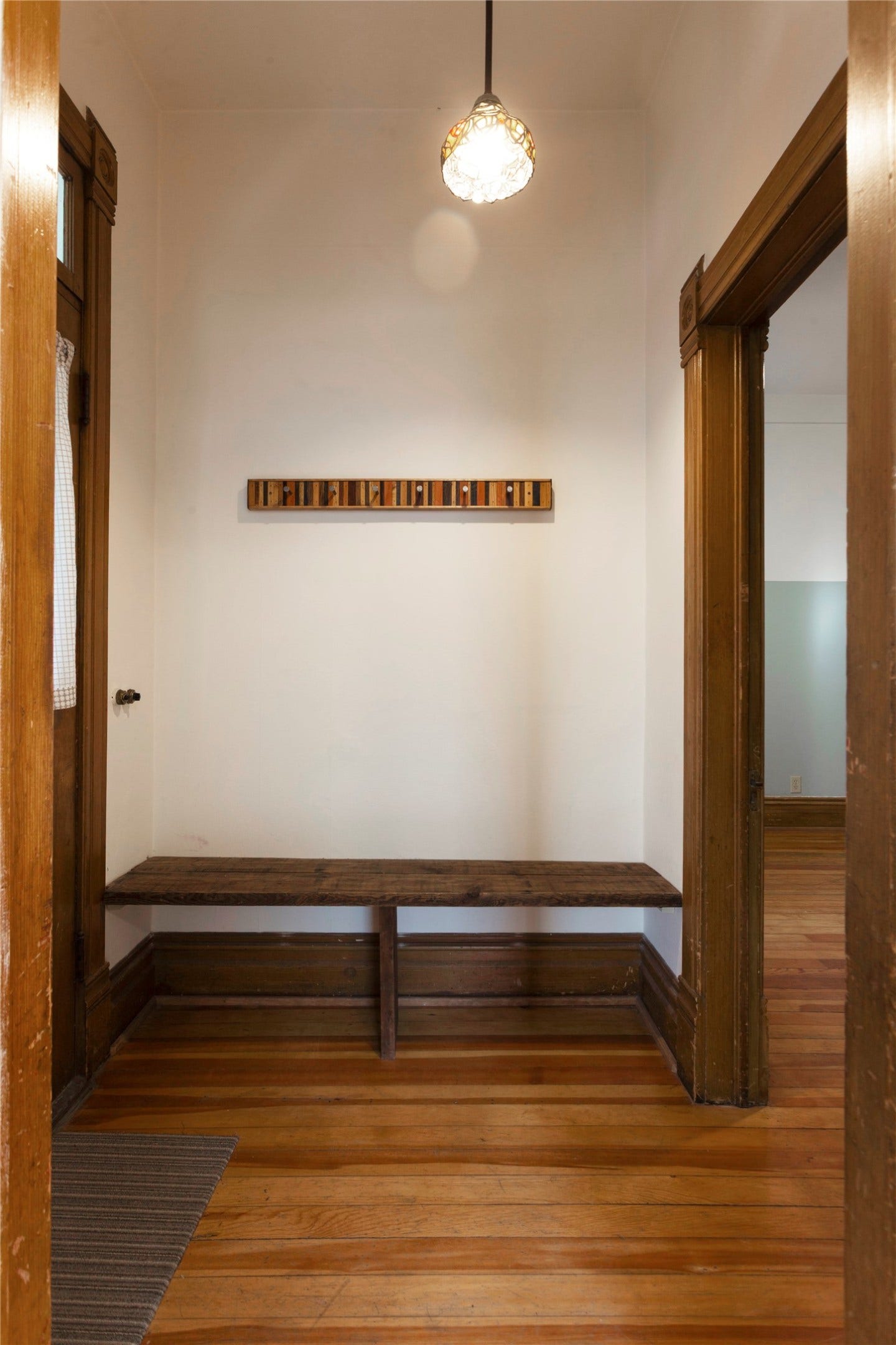Wood-finish flooring with a coordinating built-in bench