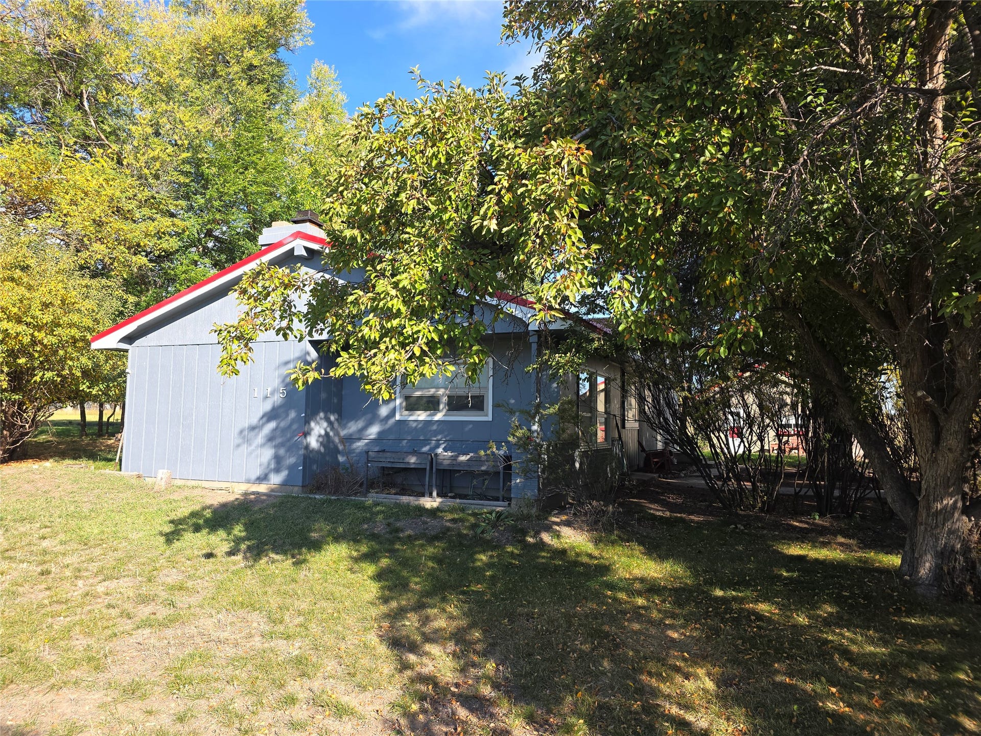 115 Ricketts Road, Hamilton, MT 59840 Light blue siding exterior with a red pitched roof