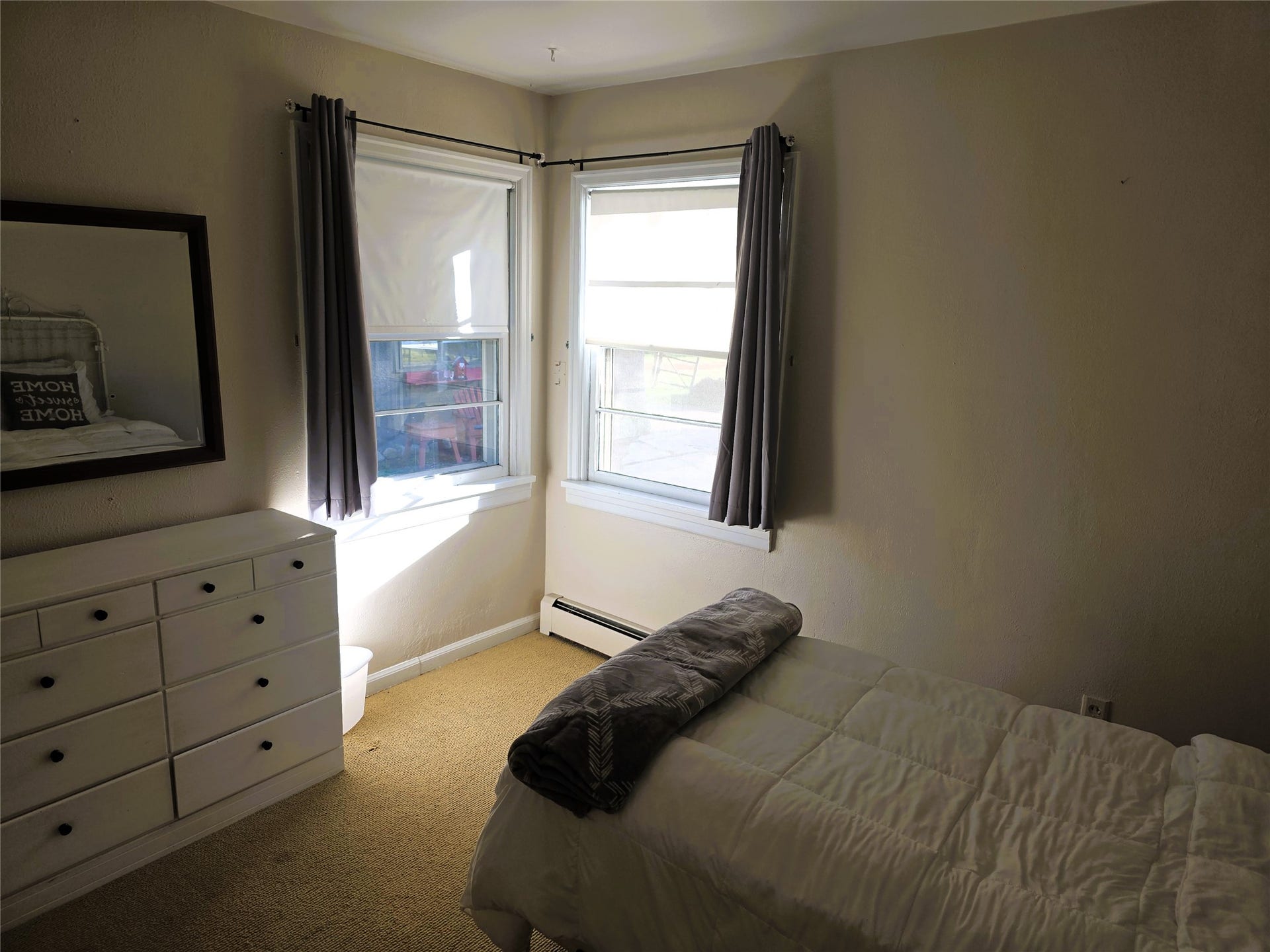115 Ricketts Road, Hamilton, MT 59840 Two casement windows with white trim, wall-mounted baseboard heating unit