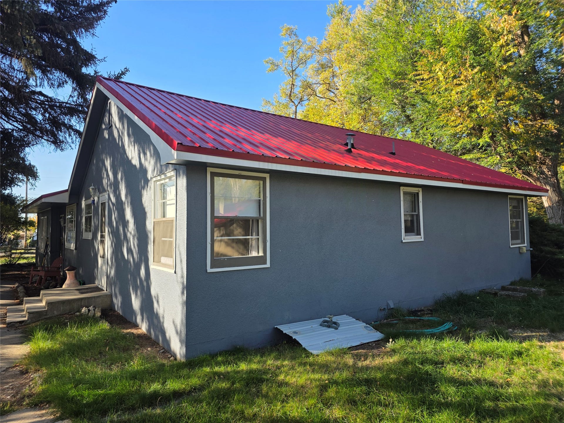 115 Ricketts Road, Hamilton, MT 59840 Gray stucco exterior with a vibrant red metal roof