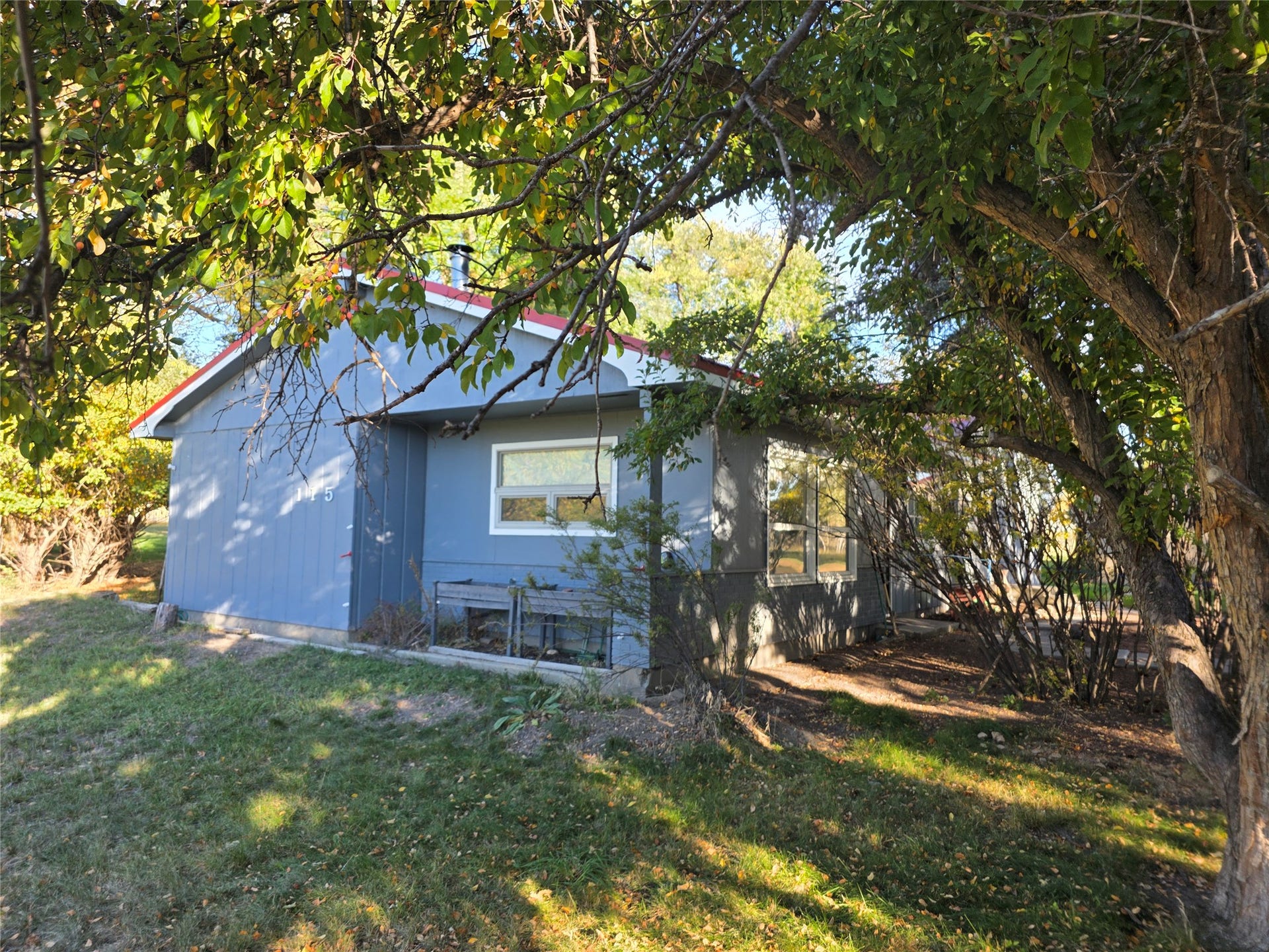 115 Ricketts Road, Hamilton, MT 59840 Blue siding exterior with white window trim and a red roofline