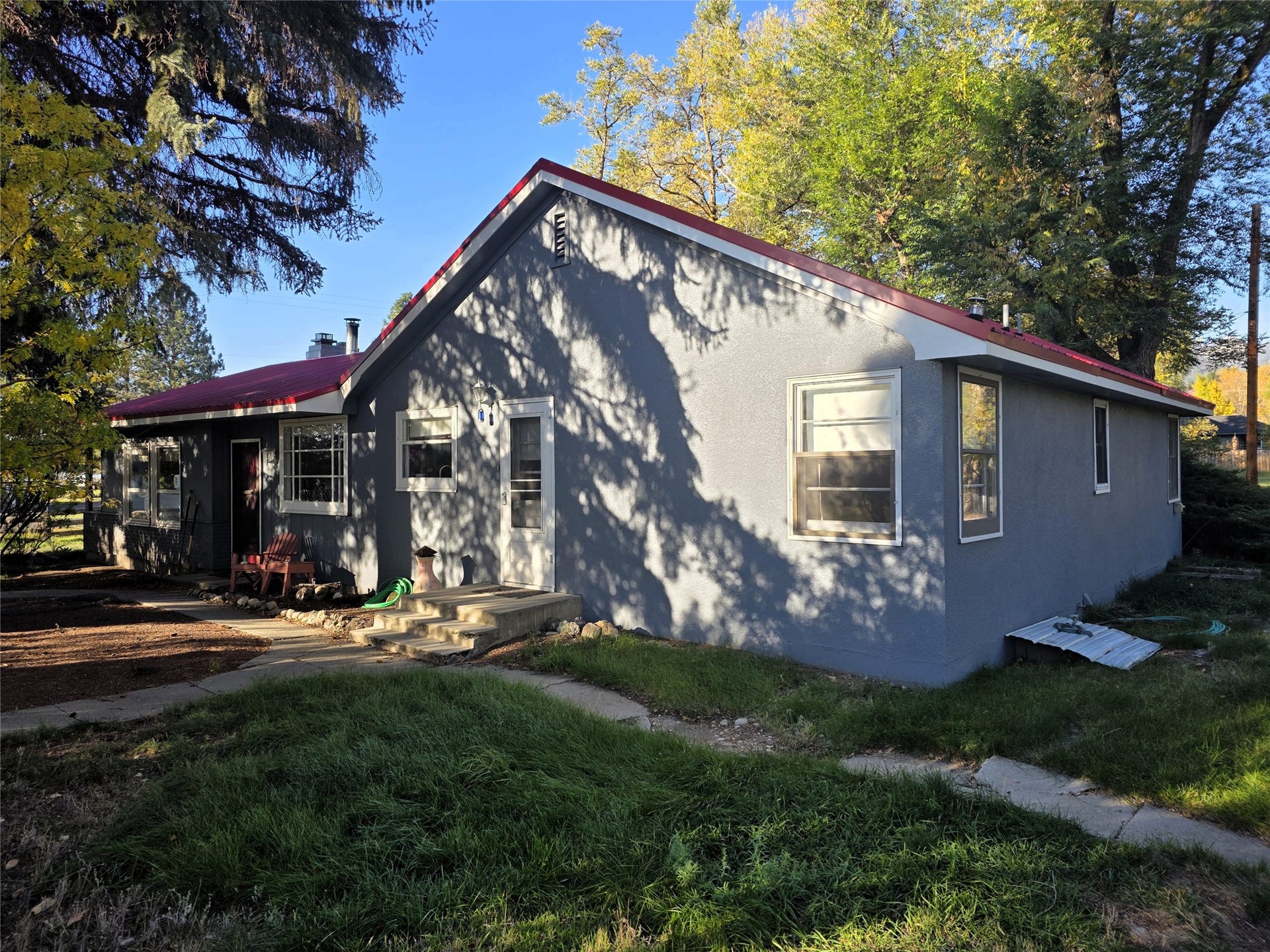 115 Ricketts Road, Hamilton, MT 59840 Exterior with a red roof, multiple windows, and a concrete pathway