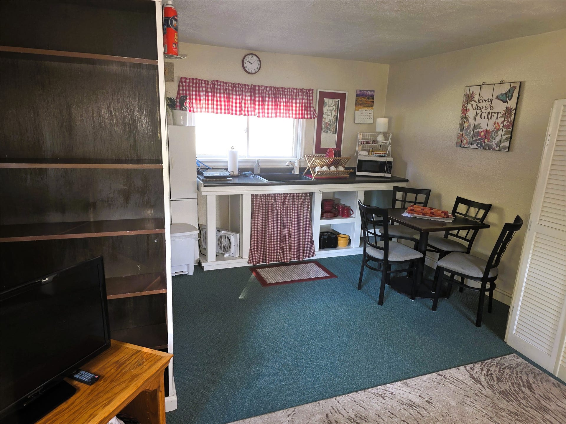 115 Ricketts Road, Hamilton, MT 59840 Kitchenette featuring a window, built-in shelving, countertop space, and sink in guest house