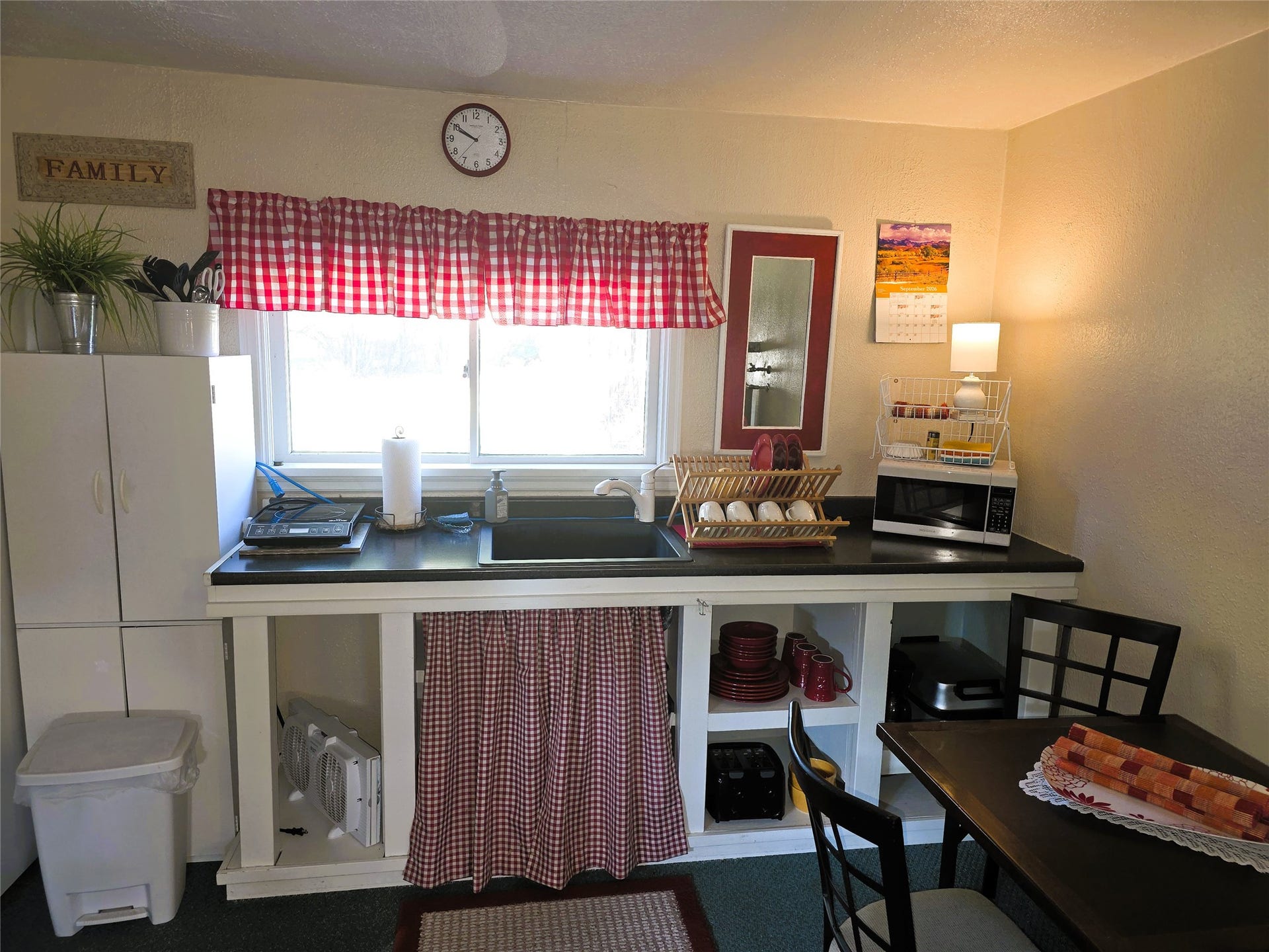 115 Ricketts Road, Hamilton, MT 59840 Kitchenette featuring a window, built-in sink, dark countertops, and integrated shelving in guest house