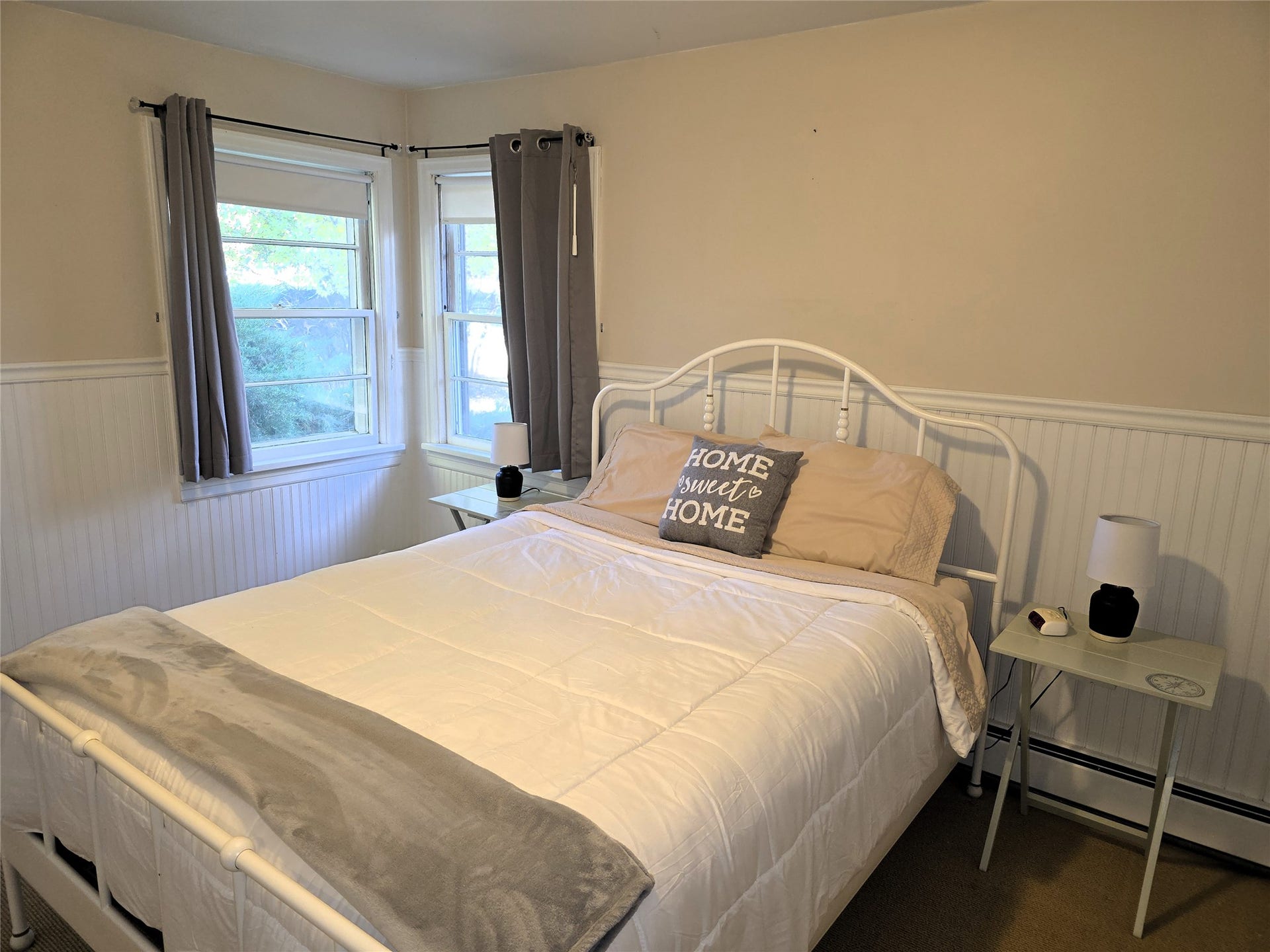 115 Ricketts Road, Hamilton, MT 59840 Dual windows with white trim, beadboard wainscoting, and carpeted flooring
