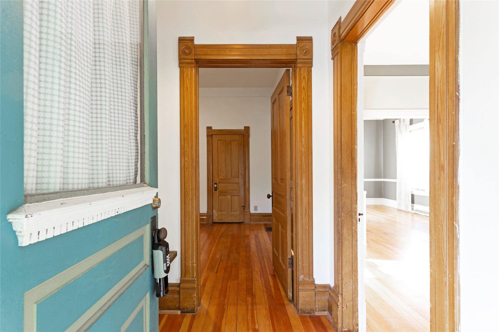 Hardwood flooring, painted interior walls, and detailed wood trim