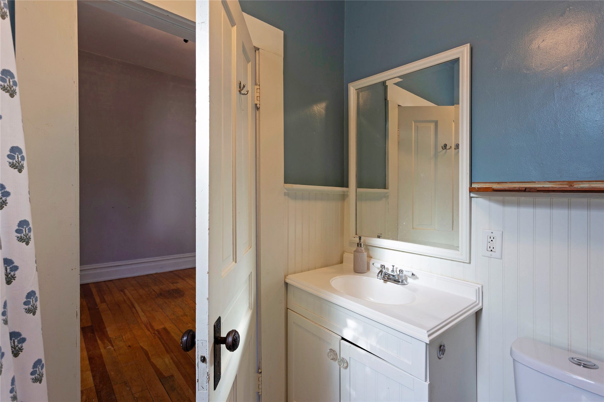 Vanity with an integrated sink, polished chrome faucet, and white cabinetry