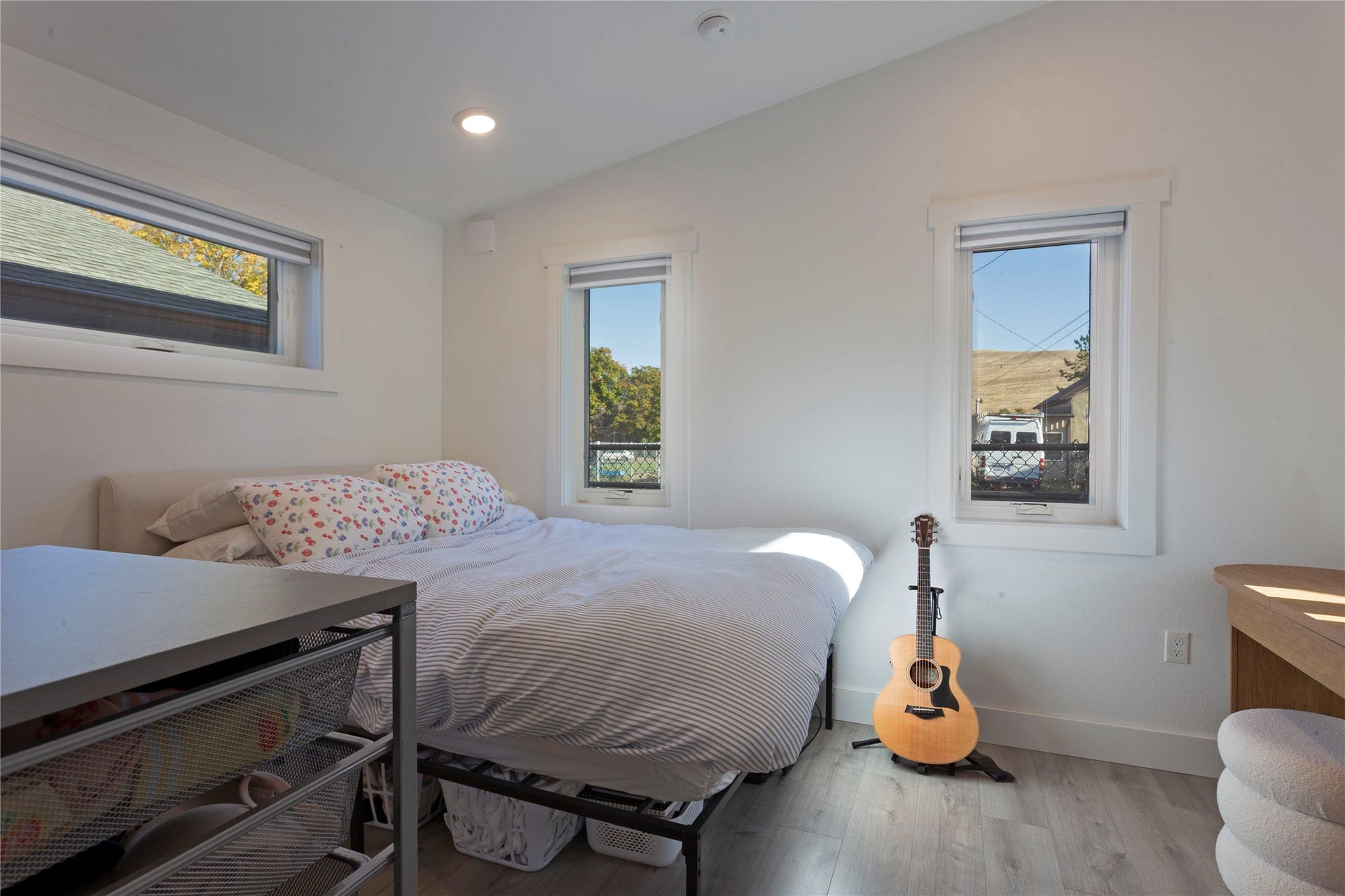 Recessed lighting, wood-finish flooring, and white walls
