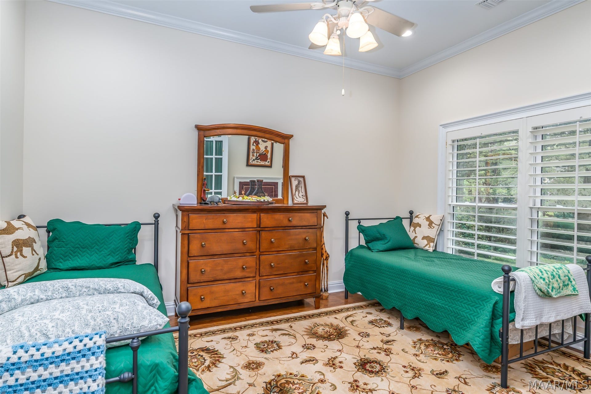1st floor bedroom or office, off the front entry, with hardwood floors, crown molding, plantation shutters and plenty of natural light.