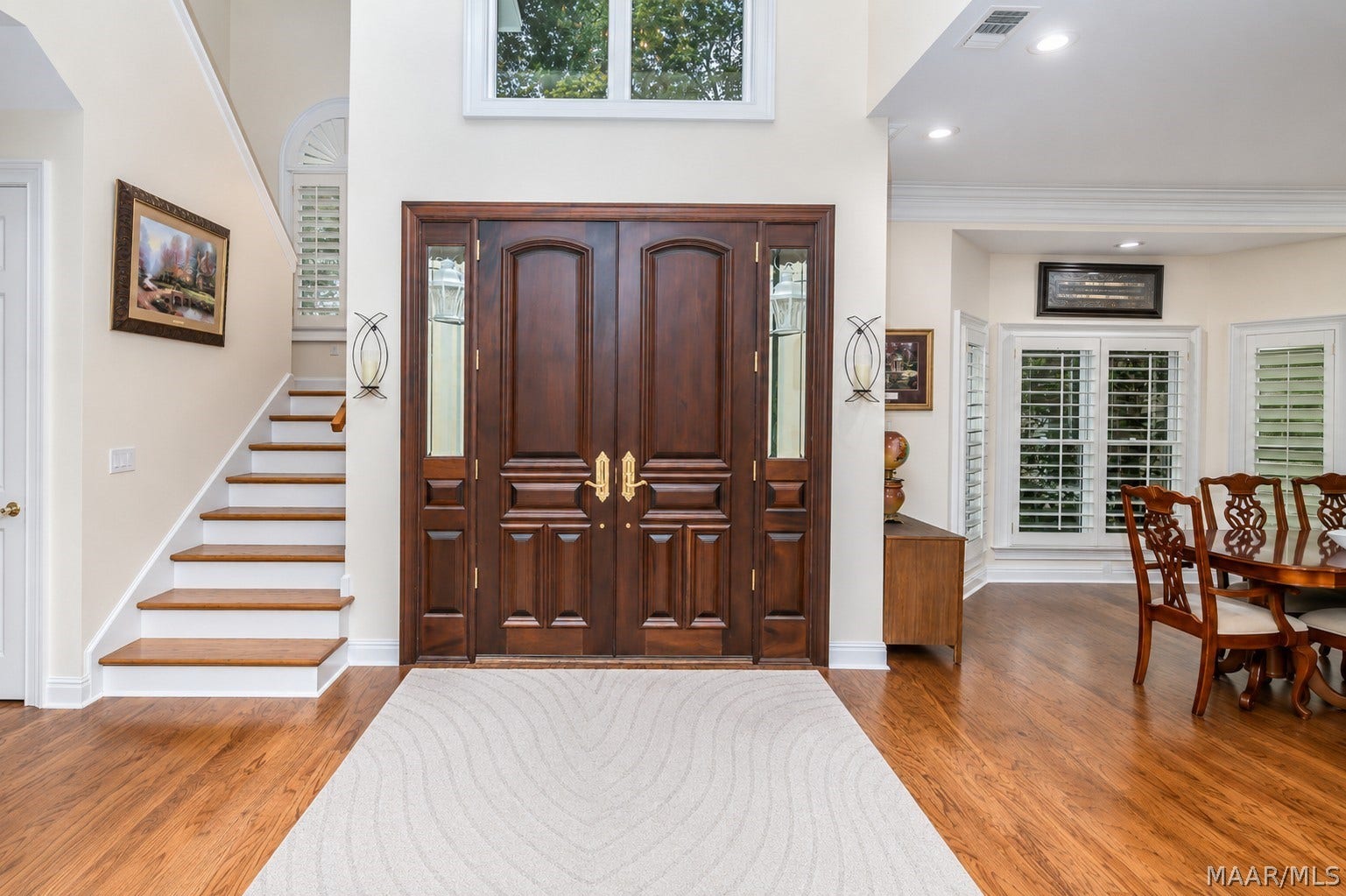 A grand, towering entrance, expansive open floor plan bathed in natural light