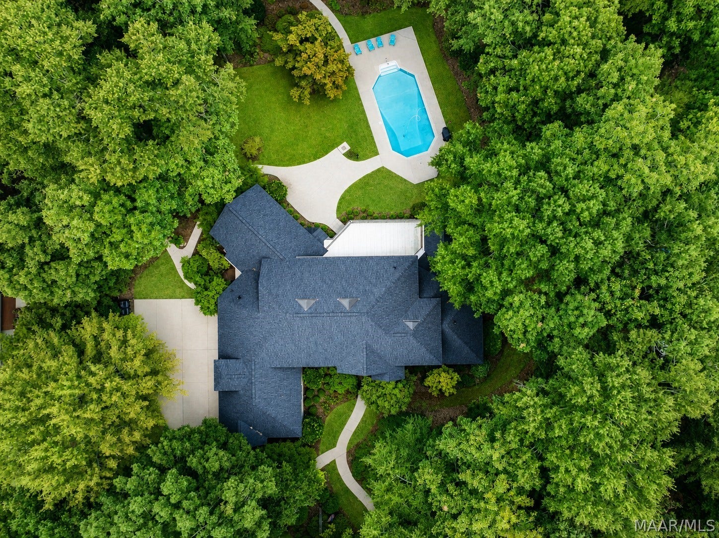 Picturesque wooded lot with lush landscaping,