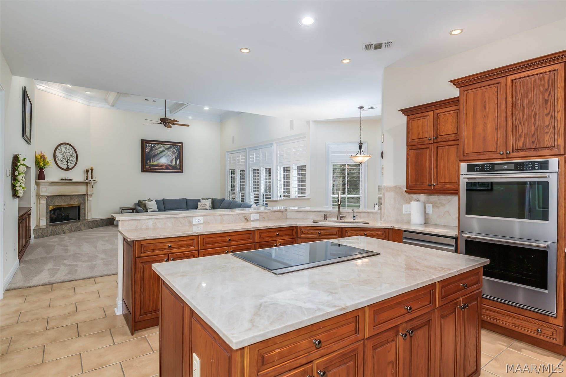 Rich custom cabinetry w/ Quarzite Taj Mahal countertops