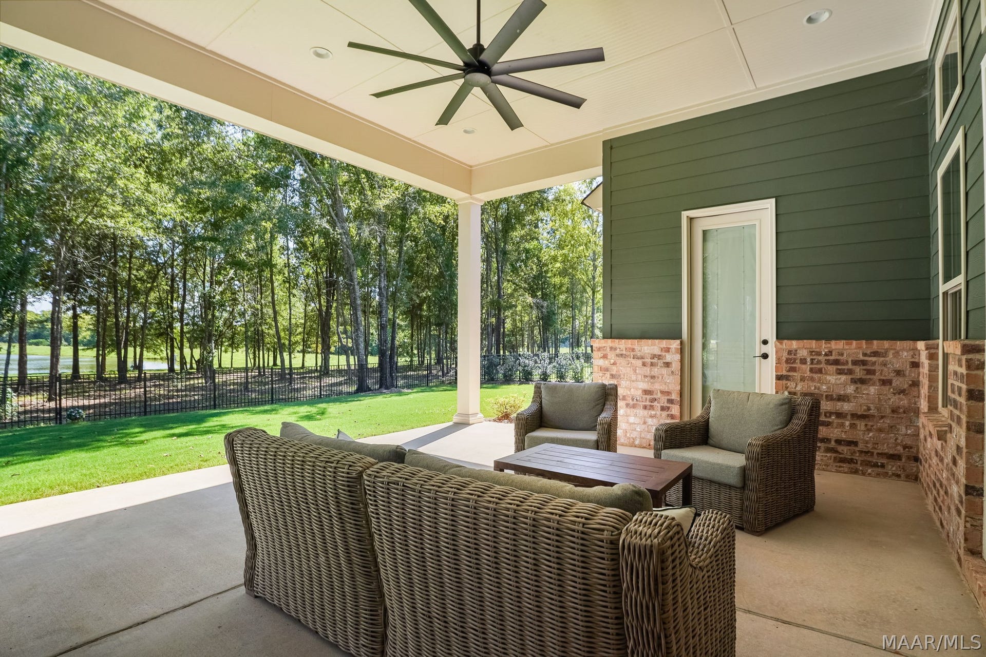 581 King's Meadow Street, Pike Road, AL 36064 Delightful patio looking out at the backyard and lake view. The door pictured leads to the primary bedroom.
