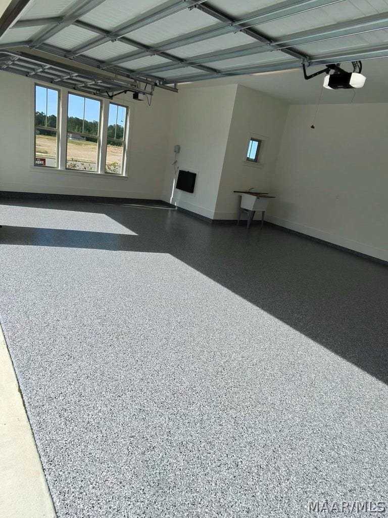 581 King's Meadow Street, Pike Road, AL 36064 Garage with epoxy floor. The package drop is top center.