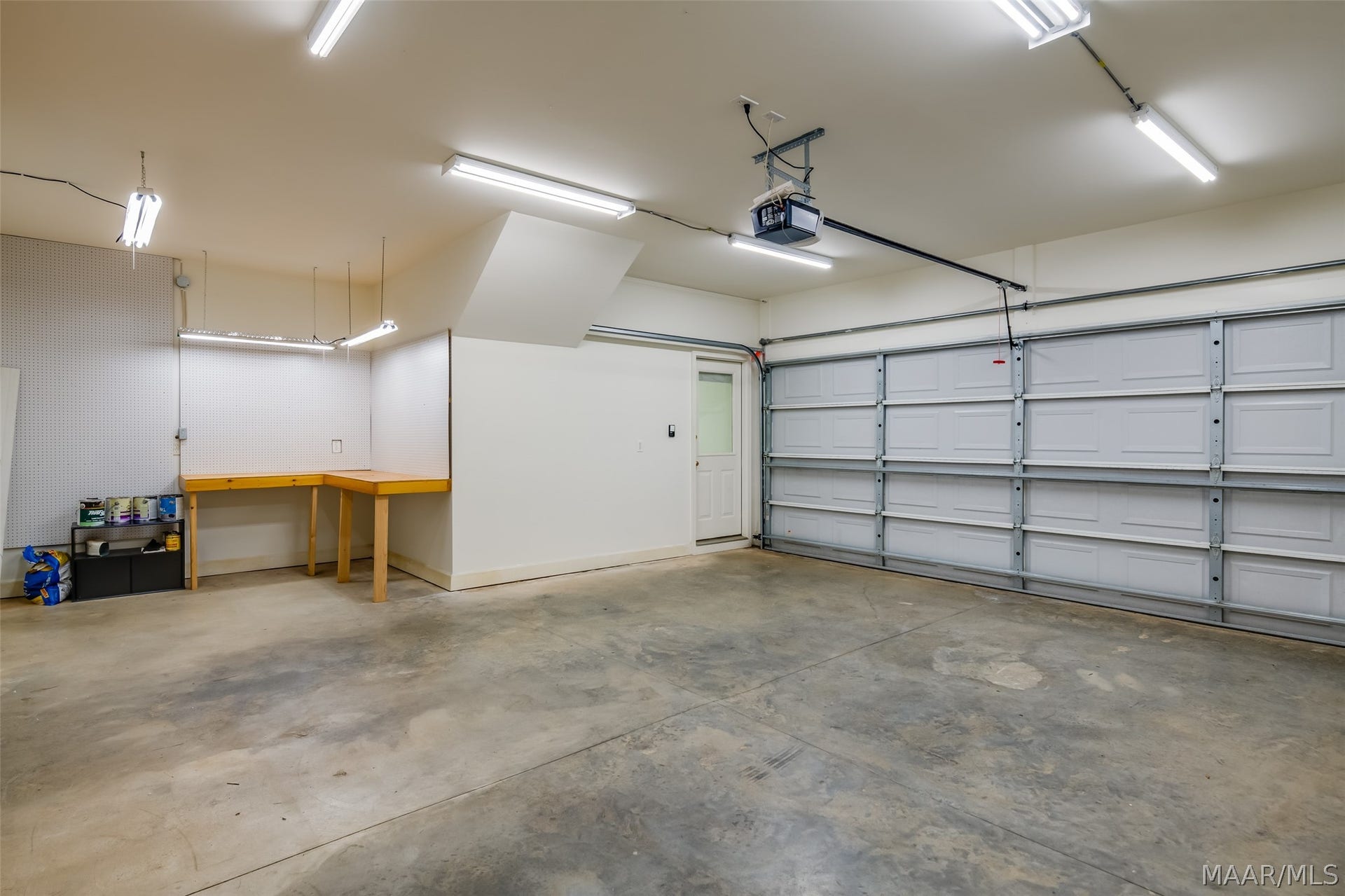Oversized garage, freshly painted & offers a work bench.