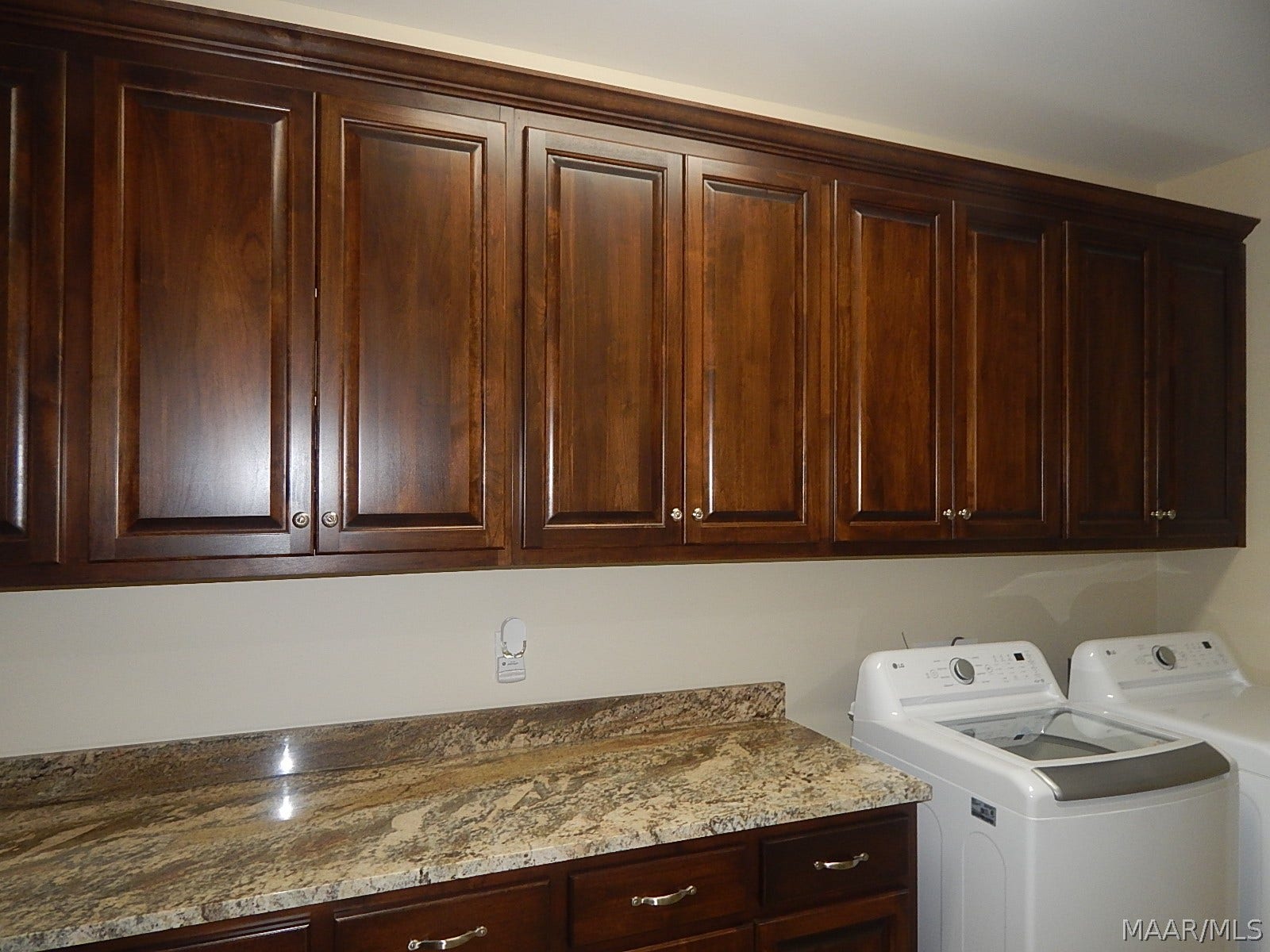 WALL OF CABINETS IN LAUNDRY RM