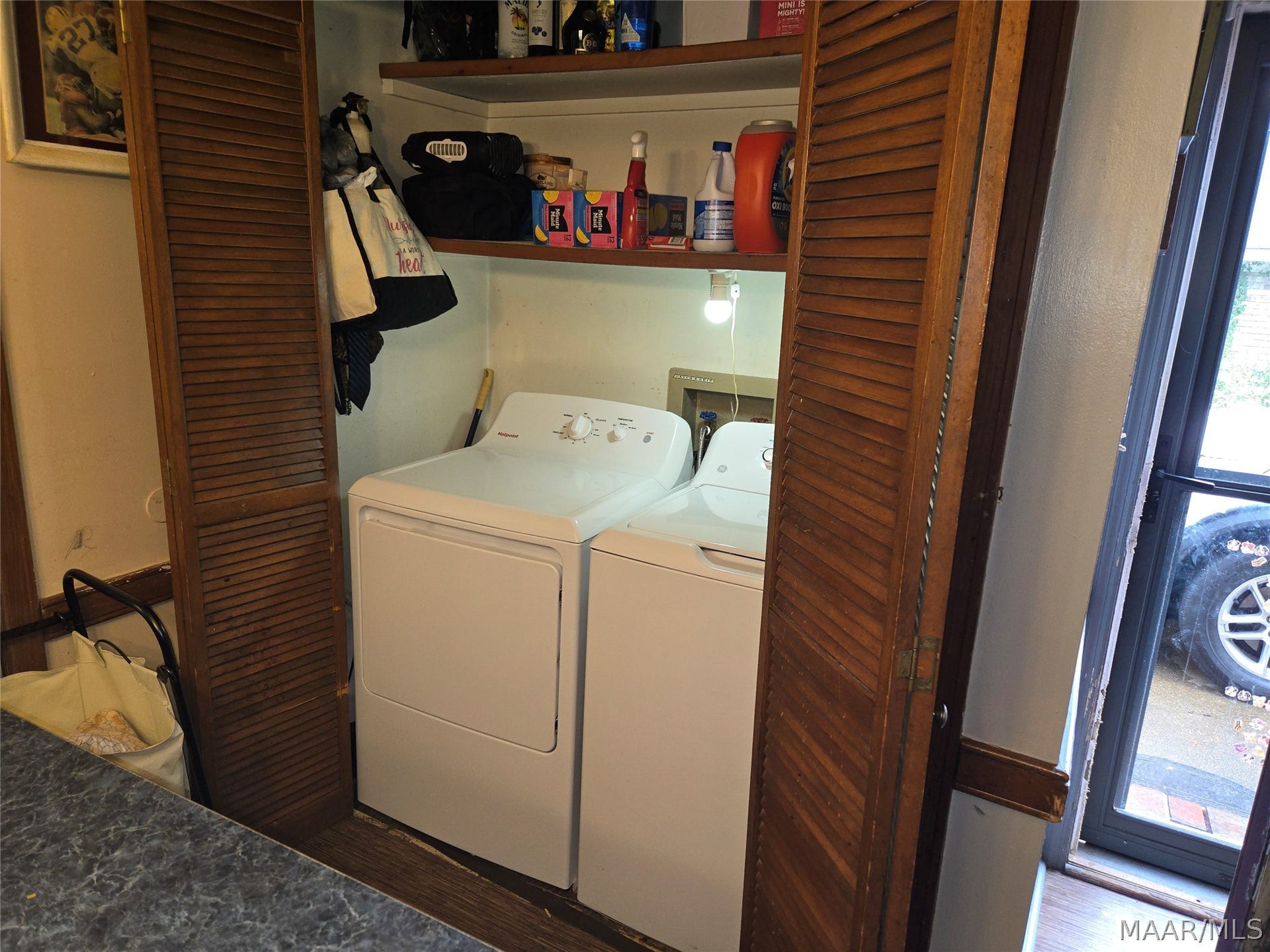 Laundry area behind folding doors